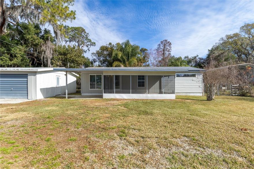 Let’s go fishing! This recently remodeled manufactured home offers an affordable waterfront lifestyle with canal access to the Lake Harris Chain of Lakes—perfect for seasonal residents, anglers, looking for a low-maintenance Florida getaway. Recent updates include new kitchen cabinets, insulated windows, new flooring, and fresh interior paint, making this home truly move-in ready.

Designed for relaxed Florida living, the home features two oversized porches—a 27' x 12' back porch overlooking the canal and a 12' x 20' screened front porch, ideal for morning coffee, evening breezes, and entertaining guests. Easy access to the water makes it simple to enjoy boating and fishing without the upkeep of larger waterfront estates.

A detached two-car garage/workshop provides abundant space for vehicles, golf carts, tools, and all your fishing and boating gear. This property is an excellent option for snowbirds, weekend anglers, or buyers seeking a second home with minimal maintenance and no need for renovations. Convenient, comfortable, and ready to enjoy—just bring your boat and start living the Florida lake life.