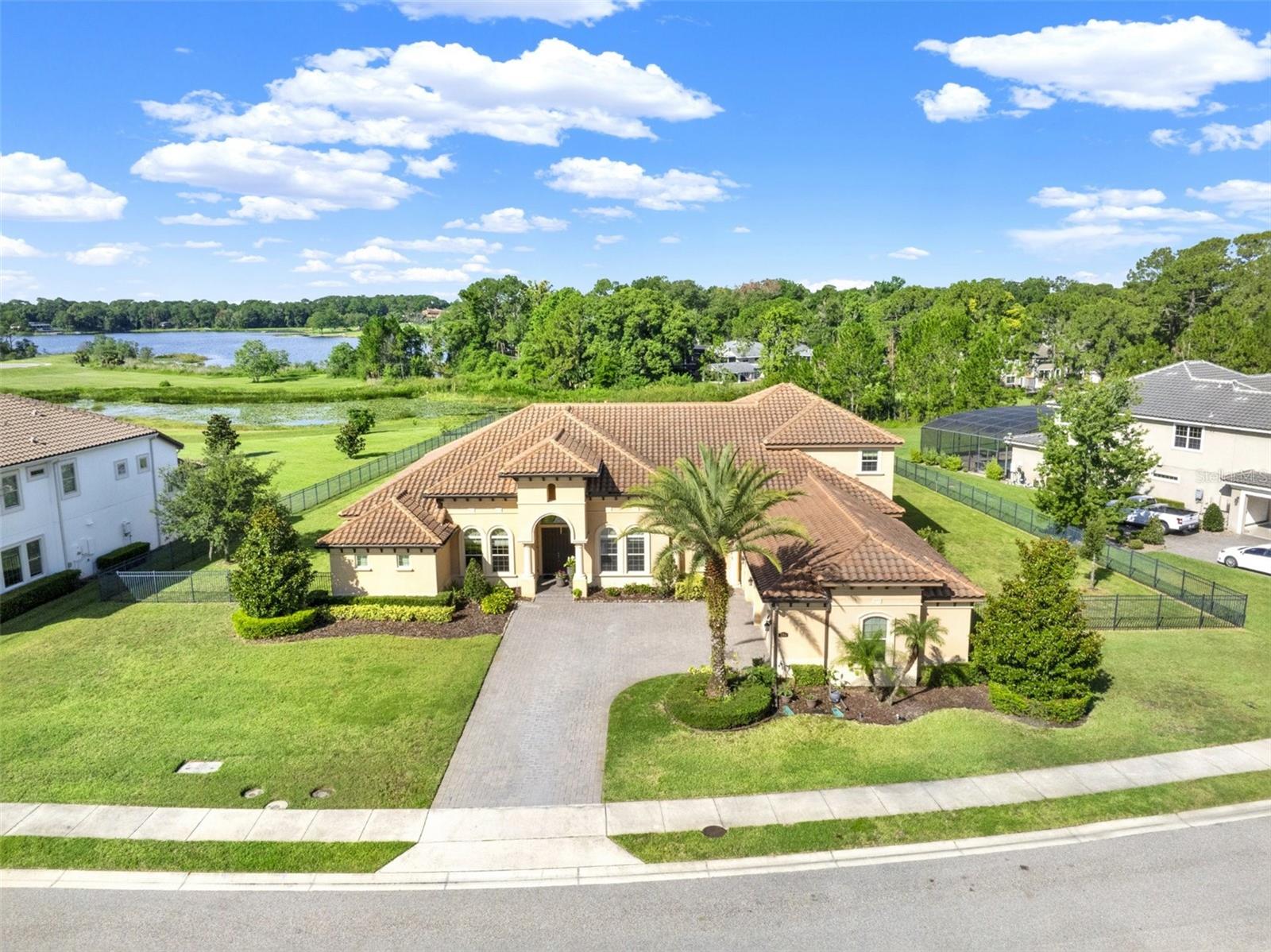 An extraordinary sanctuary awaits in the heart of Lake Mary’s sought-after Steeple Chase community, where timeless elegance, serene natural beauty, and modern luxury converge on a private one-acre estate. Perfectly positioned to capture serene views of Rice Lake and protected conservation, this residence offers a seamless blend of luxury, privacy, and natural beauty. Designed for both elegant entertaining and everyday comfort, this home features expansive living areas, soaring ceilings, and designer finishes throughout. Exquisite chef's kitchen featuring premium Sub-Zero a Wolf appliances and convenient pot filler is sure to impress. Oversized windows and thoughtfully integrated indoor-outdoor living spaces showcase the stunning backdrop and invite the outdoors in. Step outside to your own private resort-style oasis, where a sparkling pool and spa overlook the tranquil lake and lush conservation. Summer kitchen is complete with outdoor grill with a vented hood, sink, and beverage fridge. Whether you're hosting guests under the covered lanai, enjoying a sunset soak in the spa, or simply relaxing poolside in total privacy, this home delivers an unmatched lifestyle experience. Residents of Steeple Chase enjoy 24-hour guard-gated security, private park access, and a prime location near top-rated Seminole County schools, upscale dining, boutique shopping, and major roadways.