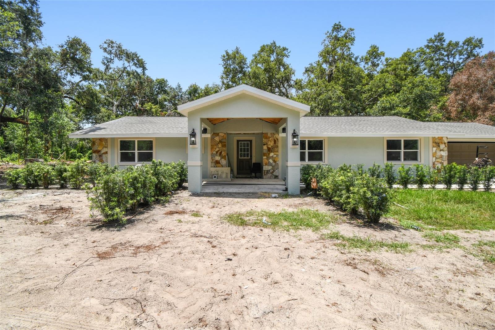 This beautifully remodeled single-family home offers the perfect blend of privacy and convenience, situated on nearly 3 acres of cleared land at the end of a quiet cul-de-sac. Accessed by a private road, the property provides a peaceful retreat just 15 minutes from the center of town, casino, shopping center, movies, theaters, Port Ybor City, and Downtown Tampa, airport, etc. The home has been fully renovated from top to bottom, featuring luxury vinyl flooring, stainless steel appliances, wood cabinetry, and elegant quartz countertops. With a spacious two-car garage and a freshly cleaned lot, this property is move-in ready and ideal for those seeking space, style, and proximity to urban amenities.