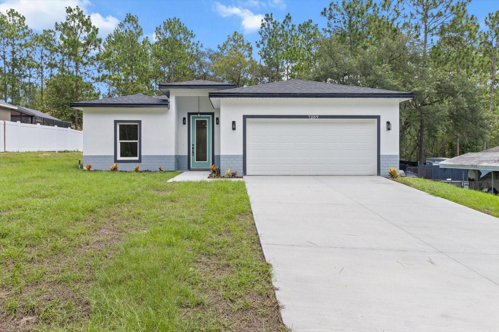 MOVE IN READY! This stunning 3-bedroom, 2-bathroom single-family home offers the perfect blend of modern design and comfort. From the moment you step inside, you’ll be impressed by the meticulous attention to detail and premium finishes throughout. The open-concept living and dining area, featuring soaring 9'4" ceilings and elegant vinyl flooring, creates a bright and inviting space perfect for entertaining. The modern kitchen is both functional and stylish, featuring custom 42” wood cabinets, Quartz countertops, a subway tile backsplash, a spacious island with seating, a generous pantry, and brand-new stainless steel appliances. The luxurious master suite offers views of the backyard and includes a spa-like bathroom with dual sink Quartz vanity tops, a walk-in shower with a soothing rain showerhead, an expansive walk-in closet, and a stylish barn door connecting the primary bedroom to the bathroom. Enjoy Florida living on the covered lanai and expansive backyard, ideal for gatherings. The 2-car garage provides ample storage for vehicles and more. Located in Citrus Springs, you’ll be just minutes from the Withlacoochee State Trail for biking and jogging, Rainbow Springs State Park for kayaking and swimming, and the Citrus Springs Golf & Country Club. Don’t miss this opportunity—schedule a showing today and make this exceptional home yours!