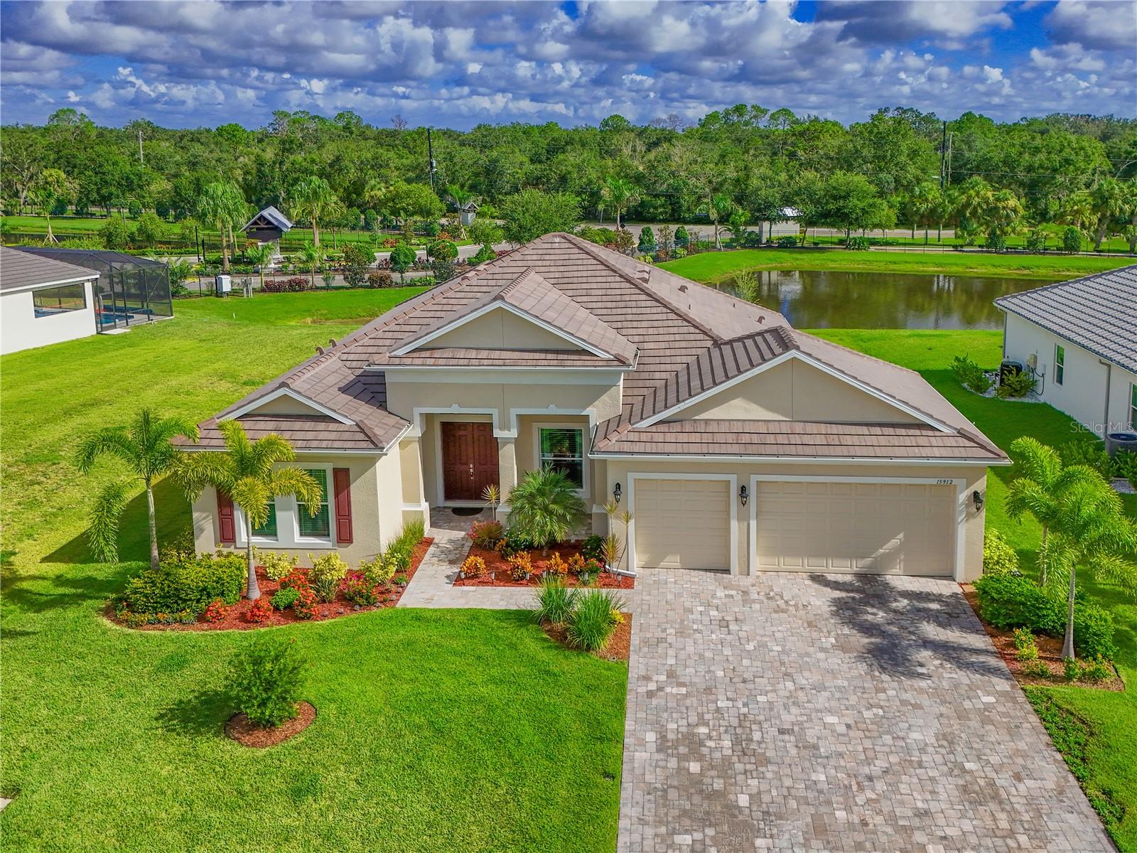 Welcome to this beautifully maintained 4-bedroom, 2-bathroom home in the gated community of Reserve at Twin Rivers. From the moment you arrive, you'll be impressed by the home’s exceptional curb appeal, featuring manicured landscaping, a paver driveway, and a durable tile roof. Step inside to discover a thoughtfully designed open-concept floorplan that offers the perfect blend of comfort and functionality. The spacious kitchen boasts ample cabinet and counter space and overlooks the living room—ideal for entertaining guests or staying connected with family while preparing meals. Just off the kitchen, you’ll find a dinette area for casual dining, as well as a separate formal dining room for more elegant gatherings. The primary suite is a peaceful retreat, complete with private access to the covered, screened-in lanai, dual closets—including a large walk-in—and a generously sized en-suite bathroom. Pocketing sliding glass doors in the living room open fully to the expansive lanai, creating a smooth indoor-outdoor flow that’s perfect for relaxing or entertaining. The large backyard offers endless potential, with plenty of space to design the pool and outdoor oasis of your dreams. An oversized 3-car garage provides abundant room for vehicles, storage, or even a home gym. HOA fees cover Spectrum TV and internet, reclaimed water for irrigation, and maintenance of all community common areas. Schedule your private showing today!