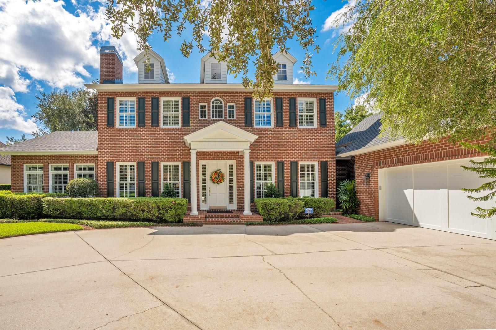 Prestigious Windsong community-Discover luxury living at its finest in this exquisite 5-bedroom, 5 full and 2 half-bathroom estate built by renowned Hal George (Parkland Homes). Boasting a traditional, red brick exterior and surrounded by a private 12 ft hedge, this meticulously maintained, light-filled home offers unparalleled privacy and modern elegance. Upon entry, you're greeted by a grand foyer, setting the tone for the home's impeccable craftsmanship and attention to detail. The main level features a well-appointed office and a spacious primary bedroom retreat that opens gracefully to the pool lanai, offering a seamless indoor-outdoor lifestyle. Beautiful primary bath features travertine marble, a spacious soaking tub, and a large shower, epitomizing luxury and relaxation. The heart of the home revolves around an open yet distinct layout, perfect for daily living and entertaining. The family, dining, and living rooms flow effortlessly, enhanced by new LED lighting and a gas fireplace for added ambiance. The gourmet kitchen is a chef's dream, showcasing granite countertops, pale oak cabinetry, and top-of-the-line appliances including a Wolf gas range, Subzero refrigerator, Bosch dishwasher, and Perrin and Rowe faucets; a window wall behind the dining banquette floods the kitchen with natural light and looks out onto the pool area and private backyard. Dual pantries provide ample storage space. Upstairs, a separate staircase on one side of the house leads to the fifth bedroom/bonus room with walk-in closet and bathroom, ideal for guests or a private retreat. Upstairs from the main living area are three bedrooms with en-suite bathrooms and a fourth “loft” room, perfect for a library, studio or playroom. Outdoors, indulge in resort-style amenities including a recently resurfaced, heated saltwater pool with a gas-heated spa, fiberoptic light tower, and Jandy Digital Assistant controller. The pool deck is at the center of a private, beautifully landscaped, backyard “room” surrounded by walls of green hedges, perfect for early morning coffee and birdsong or a glass of wine in the evening as the sun sets, washing the pool with color. The 2022 designer summer kitchen boasts marble countertops and a stainless steel Wolf gas grill. A pool bathroom adds convenience for guests. A mudroom and laundry area offer practicality and organization. Additional features include completely refinished wood floors throughout, a new security system with video cameras, a central vacuum, three AC units installed between 2015-2018, a whole house dehumidifier installed in 2023, and two hot water heaters. Outside, enjoy immaculate landscaping, a long driveway leading to a three-car garage with Tesla charging station, and serene touches like a Buddha garden. Located in the highly desirable Windsong, residents benefit from exclusive access to the Winter Park Chain of Lakes, pools and water park area for entertaining, and playgrounds. Minutes away from Park Avenue shopping and restaurants, Baldwin Park, parks, playgrounds, and excellent public schools including Brookshire Elementary, Glenridge Middle, and Winter Park High School. Don’t miss this rare opportunity to own a masterpiece in one of Winter Park’s most coveted neighborhoods. Contact us today to schedule your private tour and experience luxury living at its finest.