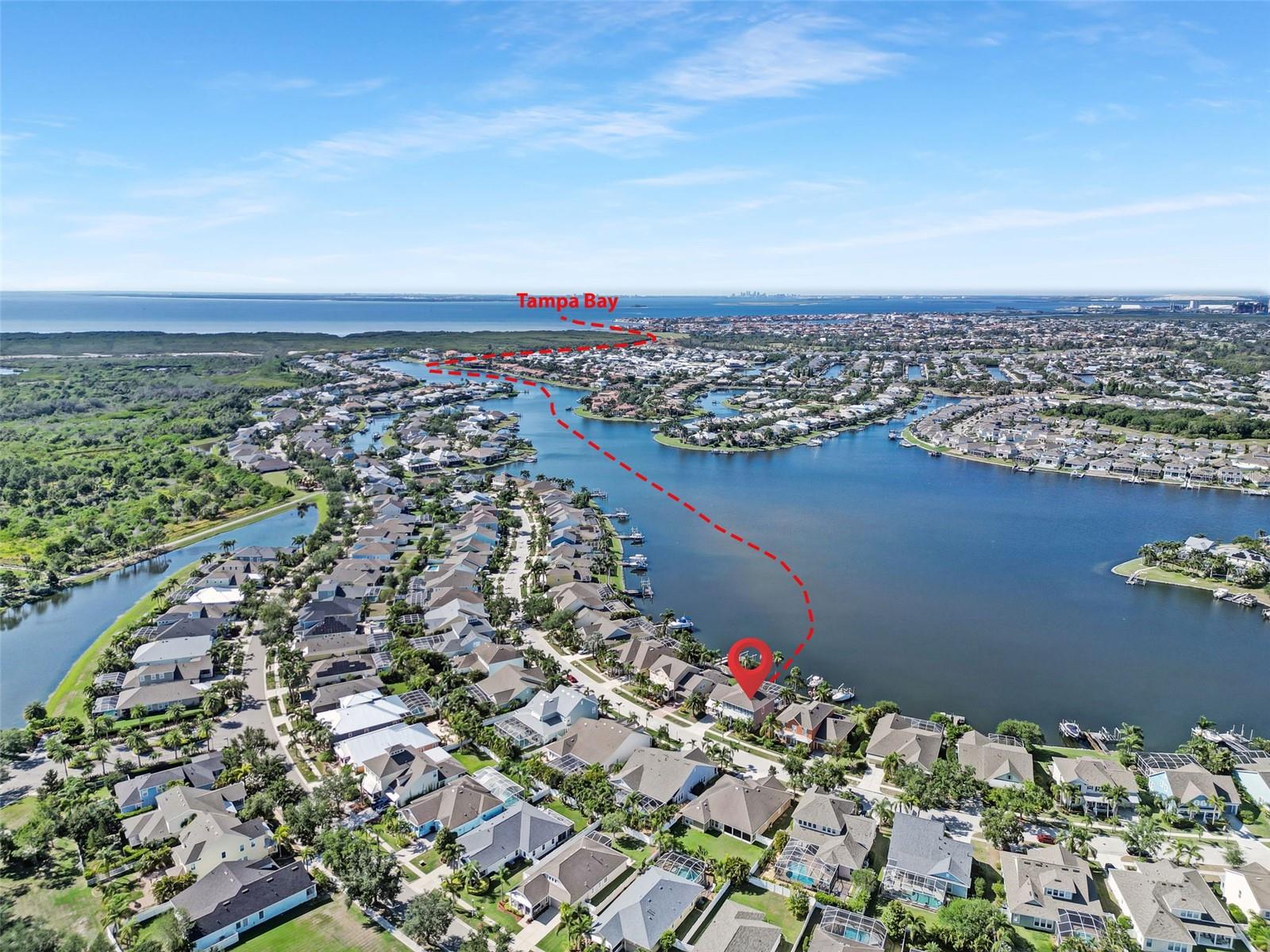 BEAUTIFULLY UPDATED David Weekley pool home with INCREDIBLE WATER VIEWS!! This waterfront stunner is complete with a fully screened, heated pool with waterfalls and infinity edge, private dock equipped with a 16,000lb boat lift AND jet ski lift. The property, the views and the home are breathtaking! NEWER ROOF! AC UNITS UPDATED IN 2020 and 2018, Tankless Gas water heater & New Pool Pump recently installed. Gorgeous, premium floors throughout! NO CARPET!! The heart of this house is an open concept White and Bright Coastal Kitchen awash in natural light and open to the stunning family room with soaring 22ft ceilings, custom built-ins AND a fireplace!! The kitchen is a chef's dream complete with plentiful marble counter space, natural gas cooktop and new double ovens. Bathrooms have stunning new vanities, countertops, mirrors and lighting. This David Weekley Manatee Model is brimming with Key West style! Upon entering, you will delight in the extraordinary Waterfront views! A home office and formal dining room are at the front of the house- both have lovely front porch views. Master suite is on the first floor and features double vanities, a large garden tub, Water views and an ENORMOUS walk-in closet. There is second, very spacious guest suite upstairs with private bath and walk in closet, along with 2 additional guest rooms with jack and Jill bathroom and a bright & airy loft with sweeping water views! Mirabay is a premier, gated, waterfront community on the south shore of Tampa Bay with amenities galore, including a resort style clubhouse and pool with cafe, gym, sauna, waterfront dining, 120ft Waterslide & junior olympic pool with lap lanes! There are tennis, pickleball and basketball courts, waterfront playgrounds, and nature trails! This highly desirable community has everything! Book your showing today because this stunning property will not last long.