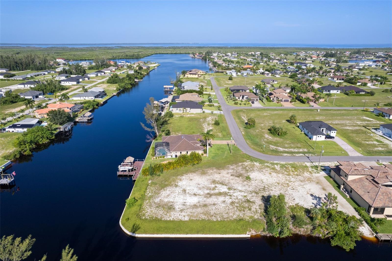 Impressive NW Cape Coral Gulf Access Lot! Build your dream home on this almost 1/2 acre lot with amazing views of intersecting canals located within a minute to the NW Spreader, direct boating access, no bridges, no locks, just serene views to Pine Island Sound. Take advantage and build right away, the Seller has already installed the Seawall (2021) with 223 square feet of water frontage. Bring your vision to life. Are you looking for a place to dock your power or sailboat, design a beautiful new home with an outdoor oasis or just looking for an amazing view. Lot survey available. Call today!