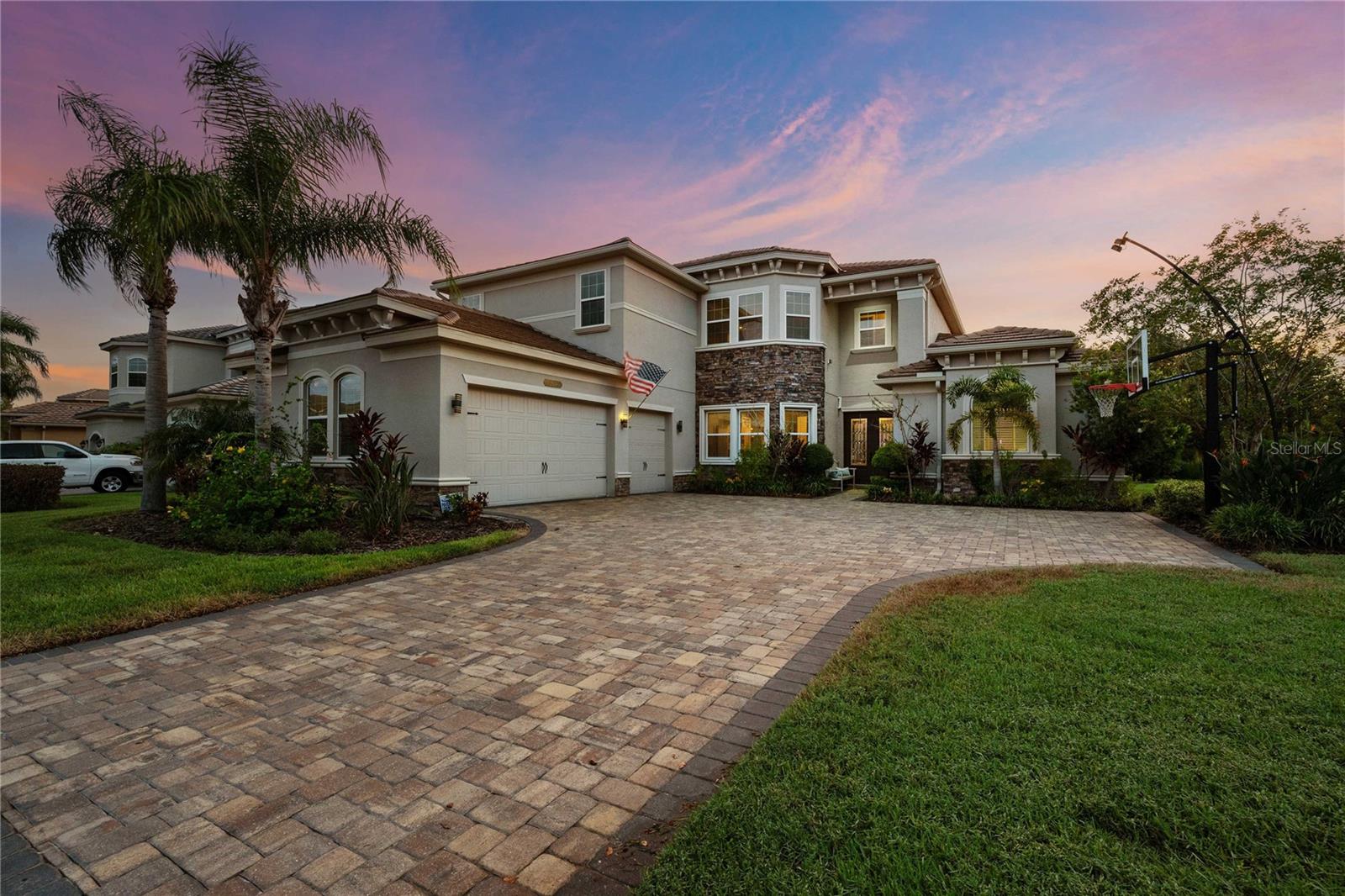 Welcome to a residence that truly embodies elegance, comfort, and resort-style living. Nestled within one of the most sought-after guard-gated neighborhoods, this 6-bedroom, 5.5-bath luxury estate has been thoughtfully designed for both everyday living and unforgettable entertaining. From the moment you step inside, the home's timeless details make a lasting impression. Rich hardwood floors flow throughout the formal dining room, stairway, loft, and private office, where double-door entry and refined finishes create a space that is both functional and distinguished. A dramatic decorative-railing highlights the stairway, adding architectural interest and elevating the home's sense of style. The chef's kitchen is the heart of the home and a dream for any culinary enthusiast. Featuring two ovens, gas cooktop, and abundant counter space, it seamlessly blends design and functionality. An open flow into the main living area, anchored by a gas fireplace, provides the perfect setting for family gatherings and entertaining guests. The thoughtfully designed floor plan offers a sixth bedroom that can also serve as a versatile game room, as well as two full laundry rooms, ensuring convience at every turn. Upstairs, a spacious loft with built-in-desk creates an ideal work or study area. The primary suite is a sanctuary of its own, complete with dual walk-in closets and a luxurious bath featuring a garden tub, oversized shower, and elegant finishes-perfect for unwinding at the end of the day. Fresh new carpeting the downstairs bedroooms adds both comfort and style. Step outside to experience true Florida living. The resort-inspired backyard showcases a sparkling pool and spa with a sun shelf, a dedicated sun deck for lounging, and a fully equipped outdoor kitchen with island seating, a keg tap, and mini fridge. With a gas BBQ line already installed, entertaining has never been easier. The outdoor living space overlooks a beautiful pond, providing stunning views and breathtaking sunsets night after night. This home is more than just a private retreat- it's part of a vibrant lifestyle community. Residents of this elegant neighborhood enjoy access to an array of clubhouse amenities designed for recreation, wellness, and relaxation. Highlights include indoor and outdoor basketball courts, tennis courts, sand volleyball, a lap pool, a zero-entry resort pool with waterslides, and multiple play areas for families. For added convenience and charm, golf carts are welcome throughout the neighborhood, making it effortless to enjoy the community's resort-like setting. Every detail of this home has been crafted to blend luxury with functionality, offering an unparalleled lifestyle in a location that balances privacy, security, and convenience . Experience the elegance, embrace the lifestyle, and make this extraordinary property your forever home.