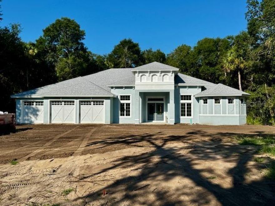 One or more photo(s) has been virtually staged. Under Construction. AMAZING CUSTOM CONSTRUCTION IN THE GATED COMMUNITY OF THE POLO CLUB OF FLAGLER BEACH, BY SIGNATURE ONE HOMES.  4035  sq ft of Custom, under roof construction on over an acre of prime land in Flagler Beach, Fl.  Close to Beaches, Golf, Tennis, shopping, houses of worship.  Close to Ormond Beach, Flagler Beach, St Augustine, Daytona Beach, not far from  Jax and the Theme Parks of Orlando.    The subject is under construction and some photos are staged. Super elegant and functional at the same time.  Ample room in almost 2800 sq ft of living area, with 4 BRs, 3 full baths, and a family room and office. 9'4 ceilings that trey up to 10'4, in well-appointed places. State of the art kitchen with quartz tops, gourmet double wall oven and cooktop in the island.  8' double door entry.  Porcelain tiled floors throughout.  Gorgeous, mitered glass nook. Several sets of large sliders across the rear, letting tons of light in and A primary bath that is award winning with SOAKER TUB abutting up against the walk-in shower! Spacious 3 CAR GARAGE w/9'4" ceiling and 8' garage doors for trucks and toys.  Plenty of under roof outdoor area to play as well...under a large, covered lanai.  All this plus 10 YEAR WARRANTY from MAVERIK (once known as BONDED BUILDERS) This home is under construction and slated to be completed by AUG 2025.  We are taking reservations and with a quick contract and certain terms, there may be time to pic certain colors and design items. This home has it all and more. Builder says construction is slightly ahead of schedule. Check updated photos:)
