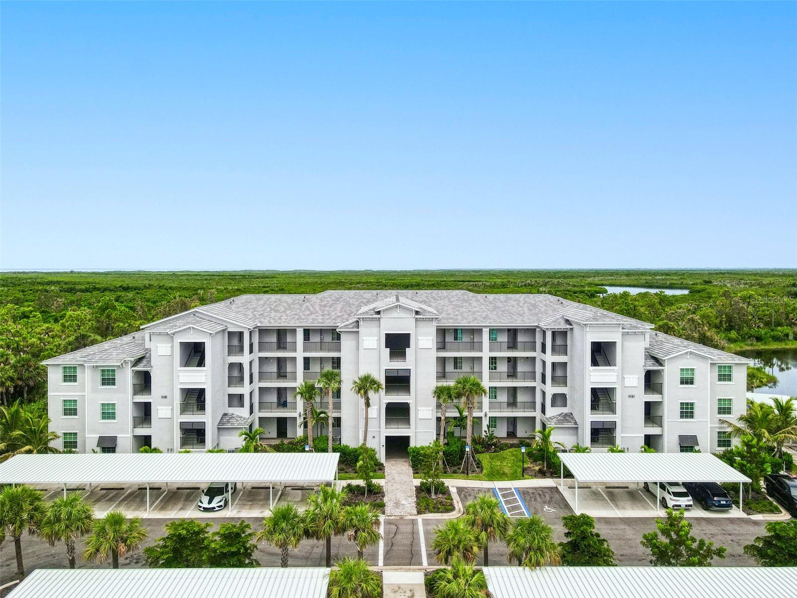 Located on the top floor of one of Heritage Landing’s newest buildings, this coveted Carolina end unit blends 2024 construction with a true resort lifestyle. Spacious 1,407 sq ft, the 3-bedroom split plan feels bright and airy, with an open kitchen featuring quartz counters, island seating, stainless appliances, pantry, and generous cabinet space. A separate dining area and spacious living room flow seamlessly to the screened lanai—perfect for savoring colorful Florida sunsets over the preserve. The primary suite easily fits a king bed and offers dual closets plus a sleek ensuite bath, while two guest rooms share a full bath with tub/shower. In-home laundry and ceiling fans add convenience. Heritage Landing pampers residents with a clubhouse offering fine and casual dining, 24/7 fitness, spa, sauna, resort-style pool with beach entry, satellite pools, Tiki bar, Har-Tru tennis, pickleball, bocce, and vibrant social events—just minutes to Charlotte Harbor and Gulf beaches.