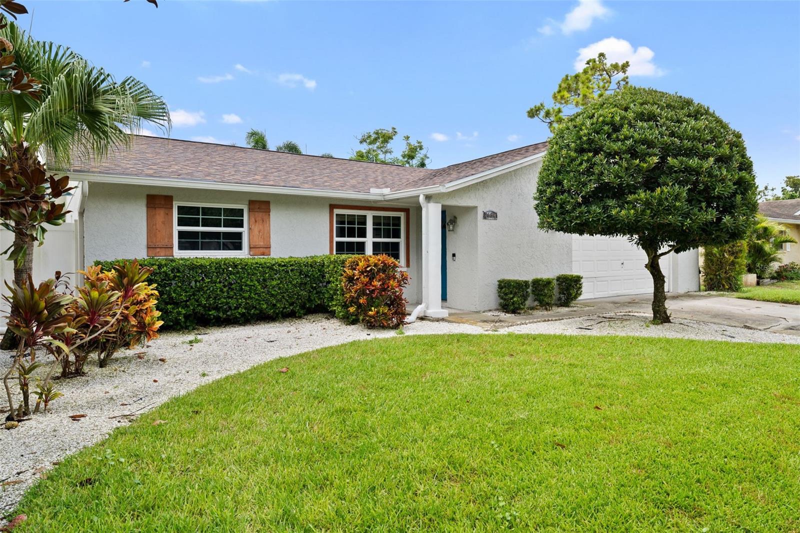 Modern and updated 3-bedroom, 2-bath, 2-car garage home located on a large fenced lot in a non-flood zone. From the moment you walk in the door, you will note the modern updates, abundant natural light and engineered wood plank flooring throughout this residence. A beautiful split-floorplan with a large primary bedroom and updated en-suite bathroom. Two sizeable bedrooms on the opposite side of the home are situated next to the hall bathroom which showcases stylish colors with a tub/shower. Make your way to the modern kitchen and you will see a generous amount of cabinetry, stainless steel appliances & center island. Heading toward the back of the home, you will find a large bonus room which could also be a great office space or secondary TV area. This room leads to a large, fenced back yard. The home has large front driveway and an attached two-car garage with a full-size washer and dryer for tenant use. Within close distance to the beaches, downtown St. Pete, grocery stores and dining. This home has it all. A pet may be considered with a non-refundable pet fee. Annual rental only.