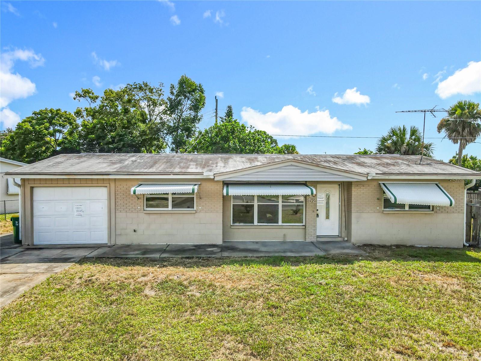 Great Opportunity on this Priced-To-Sell Block home situated on a Large Corner Lot! Perfect investment opportunity for rehab or rental. NO HOA!! This 2-bedroom, 1.5 -bath home with a 1-car garage sits on an oversized lot in Cocoa / North Port St. John—just minutes from Titusville, Cocoa Beach, and Florida’s stunning Space Coast. Enjoy close proximity to shopping, dining, schools, hospitals, and major highways including I-95, US-1, and SR-528. **SOLD AS IS. Buyer should perform their due diligence and make their own assessments. Seller responds to most offers within 24 hours, but please allow up to 72 hours. DO NOT SUBMIT OFFERS SITE-UNSEEN!