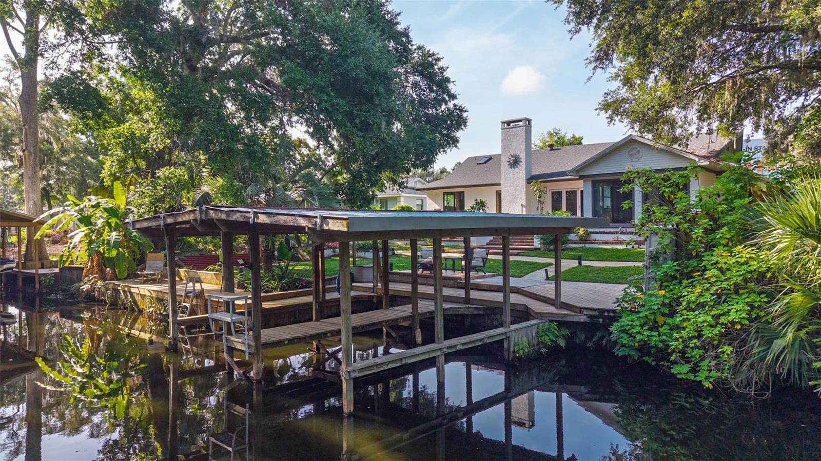 ? Price Reduction – Waterfront Paradise Awaits! ?
Welcome to a one-of-a-kind Spanish Mediterranean retreat where timeless elegance meets Florida’s natural beauty. This custom-built home sits on a canal with direct access to Lake Harris, offering two covered docks, one with a boat lift, and your own private lagoon—perfect for fishing, entertaining, or sunset cruises. you will be surrounded by a lush secret garden oasis with vibrant flowers and tropical fruit trees—orange, pineapple, banana, and dragon fruit—this home is as enchanting outside as it is inside.
In 2024, the home was fully remodeled to an open-concept layout, featuring 4 bedrooms, 3 bathrooms, and spacious living areas. The primary suite boasts peaceful water views, a walk-in closet, and custom finishes. Thoughtful updates bring peace of mind, including a new roof (2022), AC (2018), well and septic (2018), replumbing and new well parts (2024), and a new irrigation system (2024).
Along with beauty and comfort, this home is surprisingly affordable to maintain. Property taxes are lower than average, and monthly utilities stay under $300, making waterfront living easier on the budget.
Additional highlights include a private fenced side yard, ideal for pets, children, or even a separate business entrance. Located minutes from Downtown Leesburg, the Florida Turnpike, and Clermont, this property blends everyday convenience with the perfect retreat.
Come feel the calm energy of this Mediterranean sanctuary—your waterfront lifestyle awaits!