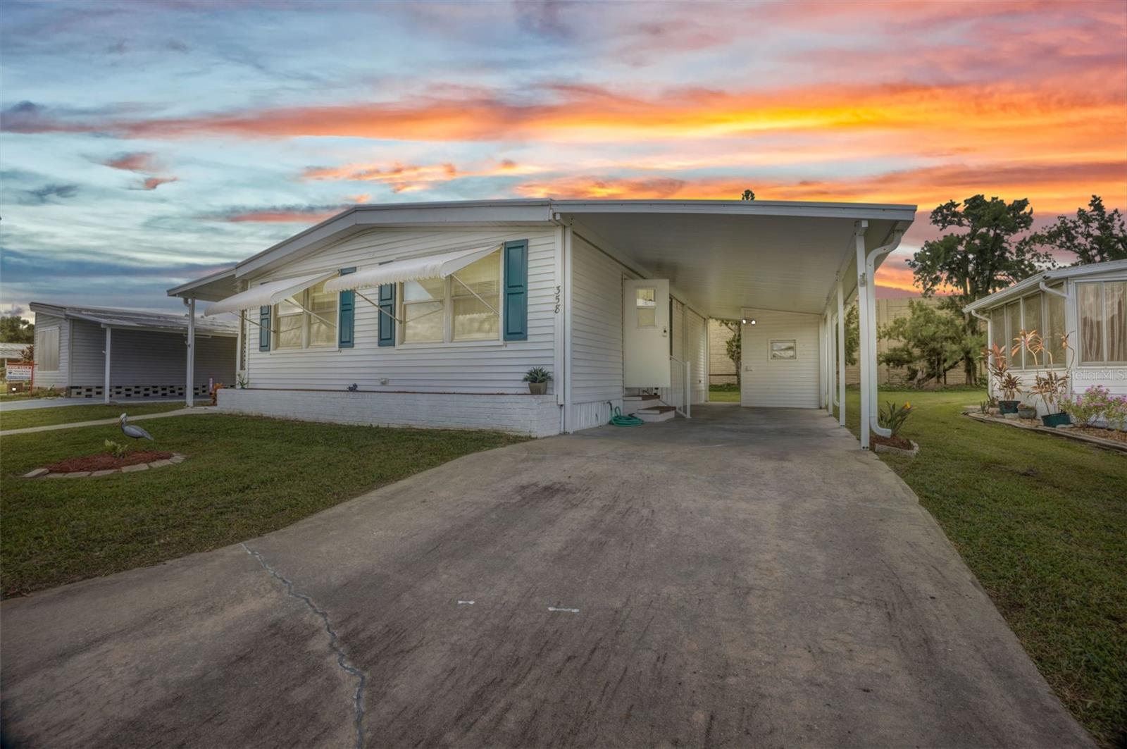 Welcome to Port Charlotte Village – Voted #1 Manufactured Home Community in Charlotte County for 2024! This updated 2-bedroom, 2-bathroom home in a desirable 55+ community offers modern style and everyday convenience with a low HOA and location outside the flood zone. Inside, you’ll find laminate flooring throughout, an enclosed Florida sunroom, and a spacious living/dining area with built-in cabinetry. The kitchen boasts newer stainless steel appliances, granite countertops, and newer cabinets, while both bathrooms have been tastefully updated. Hurricane shutters and lock-down awnings, provide comfort and peace of mind. A large carport accommodates 2 cars and a golf cart, and the storage shed includes a washer and dryer. Community amenities include: clubhouse with recreation center, dog park, meditation garden, community garden and greenhouse, lakes for kayaking, canoeing, and fishing, plus a secured storage yard for boats and trailers. Perfectly located near shopping, dining, beaches, and golf, this home offers the very best of Florida living in one of Charlotte County’s most sought-after communities.
