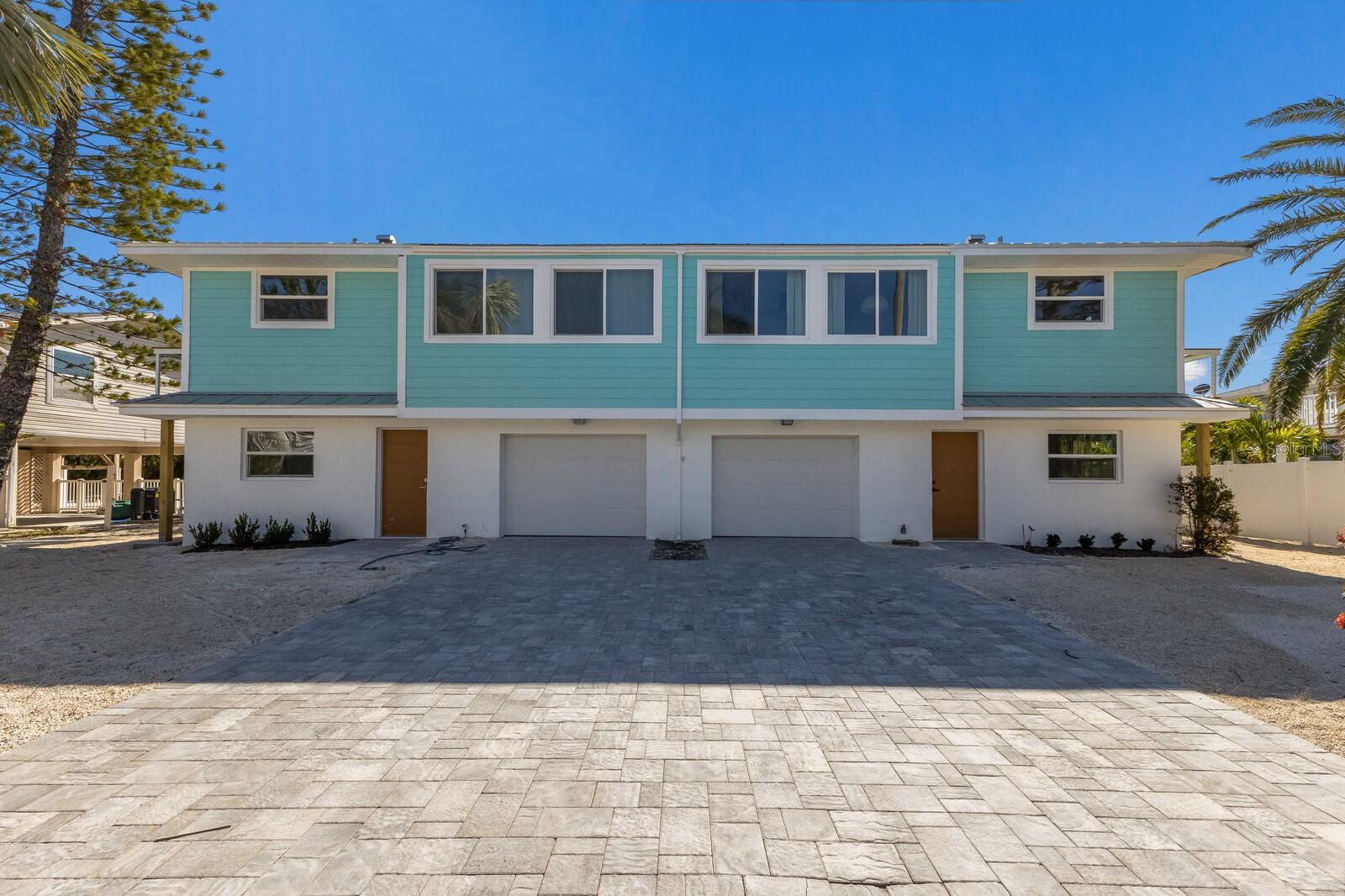 Great opportunity to own this amazing elevated beach home in Holmes Beach. You may purchase one beach villa or the entire home (duplex) for living in one side and having income in other side. This property has recently been separated into two land condos and also offered as 2 individual villas for sale or purchase both. Although this is a 2 bedroom and a 2 bathroom on each side (total 4/4) this home also offers 2 interior BONUS rooms under air conditioning for games and entertaining that lead out directly to a covered patio and very large back yard. The yard you will see has plenty of room for pools and an opportunity to create your own island oasis with landscape to your preference. If income is what you are looking for, then this home is ready to rent as a vacation rental or use one side for your family and rent the other side for added income. This home boasts an entirely new stunning remodel that includes , all brand new kitchens, vinyl flooring, new bathrooms, new metal roof, new air conditioning units, new appliances , new hurricane windows and doors, Hardie plank siding, new interior and exterior paint, and all new decking. The homes are tastefully decorated in a simple BOHO beach vibe, your guests are sure to love. Consider its very convenient location, this home is centrally positioned, just steps to the beach, and just a short stroll to the city center of Holmes Beach where you and your family or vacation guests can enjoy island shopping and dining. Lovely sidewalks near by line Holmes Boulevard and provide a great family friendly neighborhood for easy walking. Pool rendering is available and attached to listing. Book your showing today!
