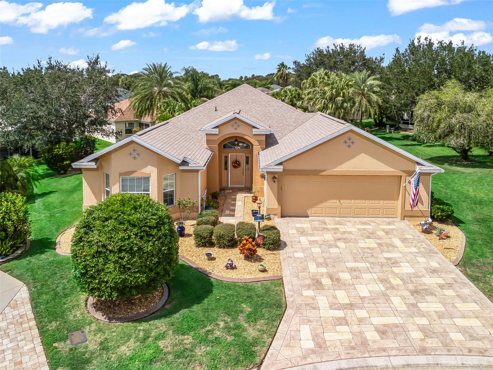 Paradise awaits in this 3 Bed / 2 Bath one owner Lantana Designer with 29’x13’ Heated Swimming Pool at the end of a quiet cul-de-sac in one of The Villages’ most convenient locations-the coveted Village of Hadley; From the moment you arrive, you'll be impressed by the picture-perfect curb appeal, featuring professionally landscaped grounds and a Stamped Concrete driveway and walkway. The landscaped exterior showcases curbing-framed rock beds with trees creating an impressive curb appeal. Situated on a generously sized 0.32-ACRE OVERSIZED beautifully landscaped lot. You enter the foyer through a welcoming front door framed by a transom window and adorned with LEADED GLASS matching sidelights. Inside, the foyer boasts Diagonal TILE floors, which continue into the Kitchen, Dining and Living rooms, creating an elegant and cohesive flow throughout the main living areas. The HIGH, VAULTED CEILINGS make the house feel roomy and comfortable. The Kitchen features Granite Counters with Tile Backsplash, Stainless Appliances, French Door Refrigerator w/water & ice in door, Recessed Lighting, Breakfast Bar with Pendant Lights, Closet Pantry & Tile Flooring. This kitchen also includes a generous breakfast nook with a window for lots of natural light. The Primary Bedroom is located in the back corner of the home for maximum privacy. This spacious Primary Suite includes Vaulted Ceiling, Carpet, extra-large closet and a bath with double vanities, zero walk-in shower, tile flooring, and a private water closet. Bedrooms two and three are located in the front corner of the house. The front Guest Room includes a Vaulted Ceiling and has a Bow Window bump out in the front. Both guest bedrooms have closets and share the Guest Bathroom which has a Tiled Shower/Tub combo. There is a Hall Linen closet. Just off the Kitchen is the Inside laundry with Upper Cabinets, Utility Sink and Tile Flooring. Other upgrades and features include-Knockdown Ceilings-No Popcorn; Exterior Paint 2023; Roof 2023; HVAC 2020; Whole House Water Purifying System 2025; Golf Cart included. Oversize 24’x25’ Garage with shelving, storage cabinets; The attic is very spacious and has flooring over the garage full length and entered thru the pull-down attic stairs. The Pool with colored lights is surrounded by Stamped Concrete and enclosed by an extra-large BIRDCAGE which is framed by Palm trees for added privacy creating a private oasis you can enjoy all year long AND you have a Poolside Outdoor kitchen for entertaining. Havana Country Club, Odell Recreation Center close by; Shopping, Dining, Banking, Medical and more available at Colony Shopping Plaza; this property is located between Lake Sumter Landing & Brownwood Town Square both with live music, restaurants, shopping, and movie theaters seven nights a week. Many golf courses and other entertainment choices, all accessible by a golf cart… Room Measurements and Square Footage are approximate and should be verified by buyer/buyer’s agent. All information is deemed reliable but not guaranteed.