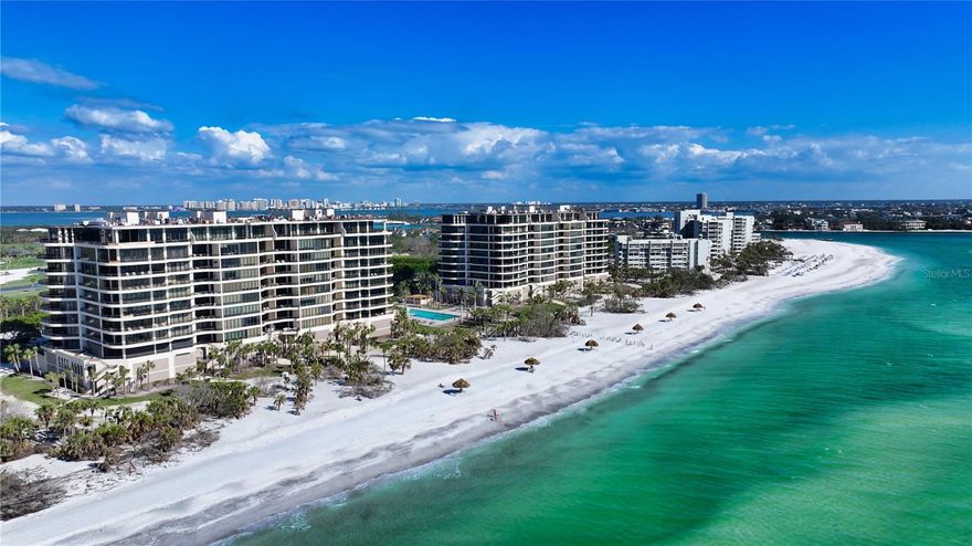 Discover Your Coastal Paradise at L'Ambiance!** Step into a world of instant enjoyment. Nestled along the stunning Gulf of Mexico, L'Ambiance offers you a front-row seat to Sarasota's dramatic sunrises and captivating sunsets. This exceptional corner residence is a rare gem, designed to help you create a lifetime of cherished memories. As you glide off your private elevator into the foyer, prepare to be mesmerized by panoramic views that seamlessly blend the indoors with the stunning outdoors. Meticulously crafted by a professional decorator, this residence is a masterpiece of elegant living, featuring expansive glass walls that invite the beach's natural beauty into your home. Enjoy the custom kitchen and luxurious bathrooms, all adorned with travertine flooring in the main living areas and plush carpeting in the bedrooms. Imagine sipping your morning coffee on the east terrace, soaking in the breathtaking sunrise, or toasting to the magical afterglow of sunset with a glass of champagne on the southwest terrace. This spacious 2-bedroom (plus den or 3-bedroom) and 3.5-bathroom residence exemplifies the pinnacle of beachside luxury. Your maintenance fee ensures a stress-free lifestyle, covering everything from the building's exterior and cable service to flood insurance and on-site management so that you can immerse yourself fully in the extraordinary island living experience. With concierge services, a resort-style pool and spa, guest suites for visitors, and a state-of-the-art fitness center, L'Ambiance offers amenities that elevate your everyday life. Sarasota's pristine white, sugar-sand beaches are just the beginning! Dive into a vibrant cultural scene to enjoy the Sarasota Opera, the Sarasota Ballet, and the West Coast Symphony. Explore the renowned Ringling Museum of Art, wander through charming art galleries and antique shops, or indulge in exquisite dining at world-class restaurants. Whether you crave the excitement of marinas and golf courses or the casual charm of local cafes, Sarasota truly has it all. Make this luxurious beachfront residence your new home and embrace the unparalleled lifestyle that awaits you at L'Ambiance. Your dream of extraordinary living is just a step away!