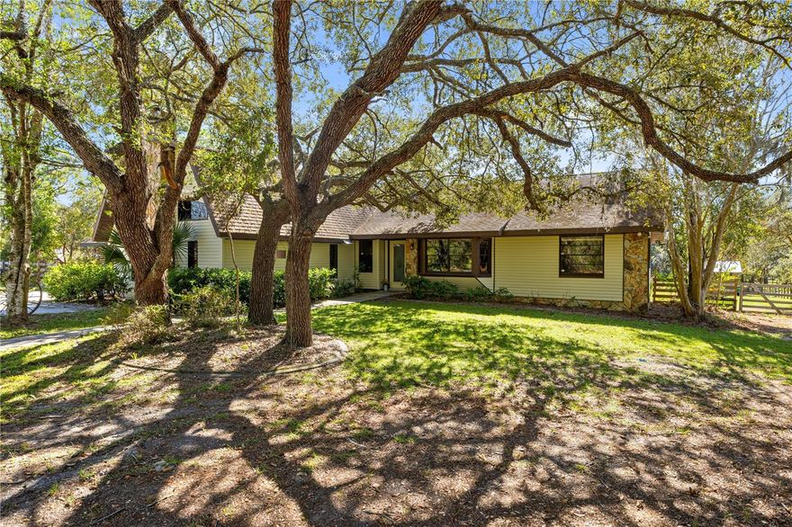 PRICE IMPROVEMENT WITH NEW ROOF AT CLOSING!! No HOA or deed restrictions at the end of a private paved road! This 5-acre property is ready to move in and bring the horses.  Home boasts 3 large bedrooms and 2 baths, eat in kitchen is open to the dining room, living room, and separate great room with a stone fireplace. Upstairs loft can be a fourth bedroom, office or hobby space. Your horses will love the  20’x50’ shedrow barn designed for optimal airflow, featuring four stalls each with an open area for feed or hay, while each stall has a 30ft corral run and all runs connect to turnout paddocks. Amenities include a wash rack, open tack area, and a separate 12’x12’ pavilion with corral, perfect for additional stabling or equipment. Horse lovers will appreciate the 100’x100’ paddock and can serve as a small arena, with two additional paddocks. Open wooded area is great for hacking the property and room for 60 ft round pen exists. Approximately two acres of open space ideal for adding more paddocks, a round pen, or another barn to suit your equestrian needs.  Property is fully fenced with separation for dogs, goats or any other family pets! Centrally located and directly abutting the sought-after Pine Ridge Equestrian community.  Too much more to list, must see!