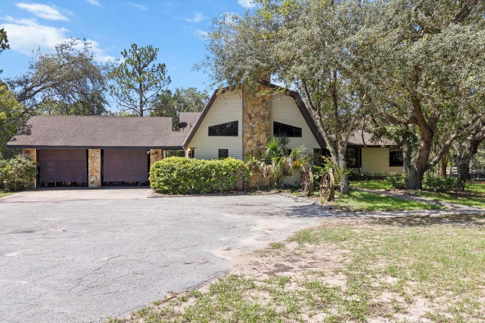 Space and serenity awaits! This 5-acre horse property offers an exceptional blend of equestrian functionality and comfortable country living. Ultimate privacy combined with mature landscaping along with no HOA or deed restrictions at the end of a private paved road! The charming 3-bedroom, 2-bath home offers a spacious and functional layout, including a split floor plan for privacy, a generous kitchen with walk-in pantry, ample living and dining areas, a cozy family room with a stunning stone wood-burning fireplace, and a loft for a home office or flex space. Your horses will love the 20’x50’ shedrow barn designed for optimal airflow, featuring four stalls each with its own 30’ corral plus an option for a fifth stall. Amenities include a wash rack, open tack area, and a separate 12’x12’ pavilion with corral, perfect for additional stabling or multi-use flexibility. Horse lovers will appreciate the 100’x100’ paddock, two additional paddocks, and approximately two acres of open space ideal for adding more paddocks, a round pen, or another barn to suit your equestrian needs. Outdoors, a 24’x24’ pavilion provides a shaded space for entertaining with picturesque views of the barn and pastures. Property is fully fenced with separation for dogs, goats or any other family pets! Centrally located and directly abutting the sought-after Pine Ridge Equestrian community. This property combines rural tranquility with convenient access to modern amenities. Enjoy all the Nature Coast has to offer, from fishing, boating, and kayaking to manatee sightings, local shopping, and quick access to the Suncoast Parkway for an easy commute. This is the perfect opportunity to live the equestrian lifestyle you’ve always dreamed of—schedule your private tour today!