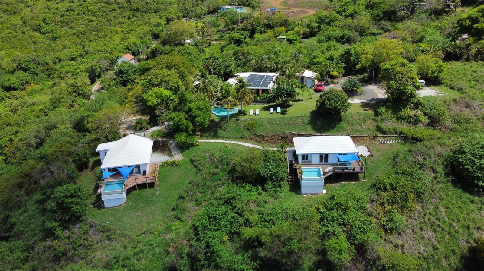 This property, Hilltop Vacation Rental Homes, is a 5 unit 5 building property located on Mount Resaca on the beautiful Island of Culebra, Puerto Rico, one of the Spanish Virgin Islands. The property has an excellent short term rental income history and has spectacular views over the Island of Culebra, Ensenada Honda Bay, the Caribbean Sea and the Island of Vieques.
The Island of Culebra itself is a small, idyllic island located about 17 miles east of the mainland of Puerto Rico and 12 miles west of St. Thomas of the United States Virgin Islands. Known for its unspoiled natural beauty, Culebra is a haven for nature lovers, beach enthusiasts, and adventure seekers. Its tranquil atmosphere, crystal-clear waters, and pristine beaches make it one of the most sought-after destinations in the Caribbean. Whether you’re looking to relax on world-class beaches, explore underwater wonders, or immerse yourself in nature, Culebra provides an unforgettable Caribbean experience.
Hilltop Vacation Rental Homes sit on the side of Mount Resaca, the highest hill on the Island of Culebra. The Homes are on two separately deeded properties integrated into 1 business comprised of the 5 buildings. The property has ample off street parking for all the buildings on the property. There is also 30,000 gallons of water cisterns and a 40 panel 12,000 Watt solar system with two Tesla power walls. The water and solar systems service all 5 of the Hilltop buildings.
The upper portion of the property has a 3 bedroom 3 bathroom "Big House", a Studio Casita, and a Studio cottage. These three buildings have a total of approximately 2700 square feet and share a large pool with the spectacular views mentioned above.
The lower portion of the property has two more buildings which are each 1 bedroom 1 bathroom houses known as Casa Maya and Casa Anya. Casa Maya is 800 square feet. Casa Anya is 700 square feet. Both Casa Maya and Casa Anya each have their own infinity plunge pools.
Hilltop Vacation Rental Homes is a very popular fully funciontal business with an excellent rental history and a high rate of return. Detailed financials will be shared with interested, qualified Buyers.
For beaches and watersports Hilltop Vacation Rental Homes are within 6 miles of all the beaches in Culebra including, but not limited to the following beaches.
Resaca Beach - 1 mile (half on foot)
Datillas Beach - 2 miles
Flamenco Beach - 2 1/4 miles
Tamarindo Beach - 2 1/4 miles
Melones Beach - 2 1/4 miles
Carlos Rosario - 3 miles (3/4 mile on foot)
Soldier's Point - 4 1/4 miles
Brava Beach - 4 1/2 miles (3/4 mile on foot)
Zoni Beach - 5 3/4 miles
Hilltop Vacation Rental Homes is also just 1 1/2 miles from the town of Dewey, the only town in Culebra which is the center of all services and amenities in Culebra including, but not limited to, government services, public services, public transportation, post office, schools, police station, fire station, hospital, banking, churches, hardware stores, gift shops, dive shops, watersports, restaurants, nightlife, and more.
For traveling Hilltop Vacation Rental Homes are 1 mile from the Culebra airport and 1 1/2 miles from the Culebra ferry dock.
All in all Hilltop Vacation Rental Homes is a spectacular property in a spectacular location with an excellent investment potential as either a fully operational guesthouse or to live in one unit and rent the rest of the units for a high Return on Investment.