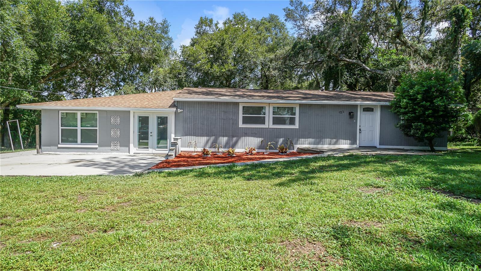 Welcome to this fully renovated single-family home sitting on a spacious 1/3-acre lot with mature trees and plenty of
parking for a growing family. Every detail has been updated for comfort and peace of mind, including brand-new windows
and doors, new drywall throughout, fresh paint inside and out, and a completely updated electrical system with a new
panel. The home features durable LVT flooring throughout, new tile in wet areas, LED lighting, and ceiling fans in every
room. The kitchen is the heart of the home, offering new cabinets, granite countertops, and all new appliances, perfect
for family meals and gatherings. Both bathrooms have been beautifully remodeled with exotic tile and modern fixtures,
while the cozy living room decorative fireplace creates a welcoming space to relax. Additional updates include a brand-new water
heater and a new air conditioner with a 1-year labor and 10-year manufacturer warranty. With a flexible floor plan that
can easily be converted into a 4-bedroom, 2-bath layout, this move-in ready home offers both style and room to grow.