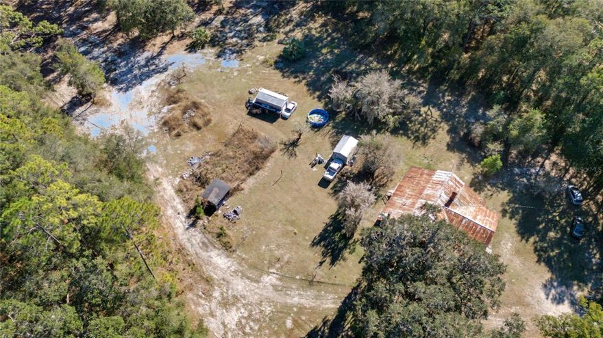 Prime Commercial (with Residence) Opportunity in a High-Visibility Growth Corridor Positioned in a heavy-traffic gateway through the Ocala National Forest, 815 NE 145th Avenue Road, Ocala, FL 34488 presents a rare and highly versatile land opportunity with exceptional exposure. Run your business and live on the property.  Front 2 acres are Residential; Rear 8 acres are Commercial. This expansive 10.12-acre parcel includes 2 acres of Commercial zoning along with 8.12 acres of Agricultural Mixed-Use, offering outstanding flexibility for a wide range of development concepts. With prominent frontage on SR 40, a major east–west corridor carrying 20,000± vehicles daily, the property benefits from continuous visibility and easy access—ideal for businesses and developments that thrive on traffic and convenience. Potential uses include a mobile home park, RV park, recreational park, multifamily housing, gas station, restaurant, school, or other high-demand commercial or mixed-use projects. Surrounded by the natural appeal of the Ocala National Forest yet strategically located along a critical commuter and tourist route, this property uniquely blends commercial exposure, scale, and zoning diversity. An excellent opportunity for investors, developers, or owner-users seeking a high-impact location with long-term growth potential in one of Central Florida’s most traveled corridors.  Also under: GC536131