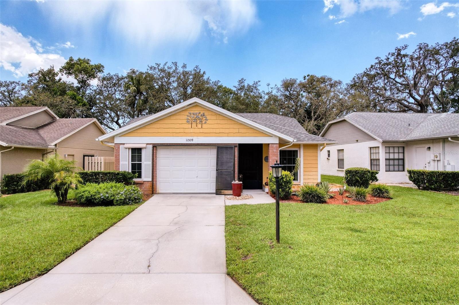 Tee Up Tranquility in This Rare 3-Bedroom Beauty at Arborwood at Summertree! Bright, open, and spacious—this lovingly maintained home is one of the few true 3-bedroom residences in the community, offering prime positioning for both comfort and lifestyle. Nestled in a peaceful setting where sandhill cranes casually stroll the yard and sunsets often put on a show, this is Florida living at its most relaxing. Inside, you’ll find expansive 24" x 24" ceramic tile flowing throughout most of the home, creating a cohesive and airy feel that complements the vaulted ceilings and oversized living room (15x23). The kitchen offers plenty of space for prep and storage, while the vinyl-enclosed rear patio is the perfect spot to sip coffee and watch nature pass by—whether it’s cranes, cardinals, or a gentle breeze rustling the palms.
Designed with both golfers and entertainers in mind, the oversized 1.5-car garage offers plenty of room for your car and your golf cart—so you’re always just a quick ride away from Summertree’s beautifully maintained public course. Updates include a new roof in 2014, energy-efficient windows in 2019, appliances replaced in 2016, and tile flooring in 2017. The garage door was just serviced with new springs and comes with a transferable warranty through 2025 for added peace of mind. Hurricane shutters, central air, and an east-facing front exposure round out the features that make this home both beautiful and functional.
Set within the gated, 55+ Arborwood section of Summertree, residents enjoy low maintenance living and access to a full suite of resort-style amenities: clubhouse, pool and spa, fitness center, tennis and pickleball courts, walking trails, shuffleboard, and of course—the golf course. The HOA fee includes basic cable, lawn care, exterior paint . Conveniently located near shopping, dining, medical services, and the Gulf Coast's sparkling waters, this home offers a perfect balance of nature, neighborhood, and recreation. Whether you're birdwatching from your back porch or heading out for a round on the greens, 11539 Pear Tree Drive is where comfort meets lifestyle.