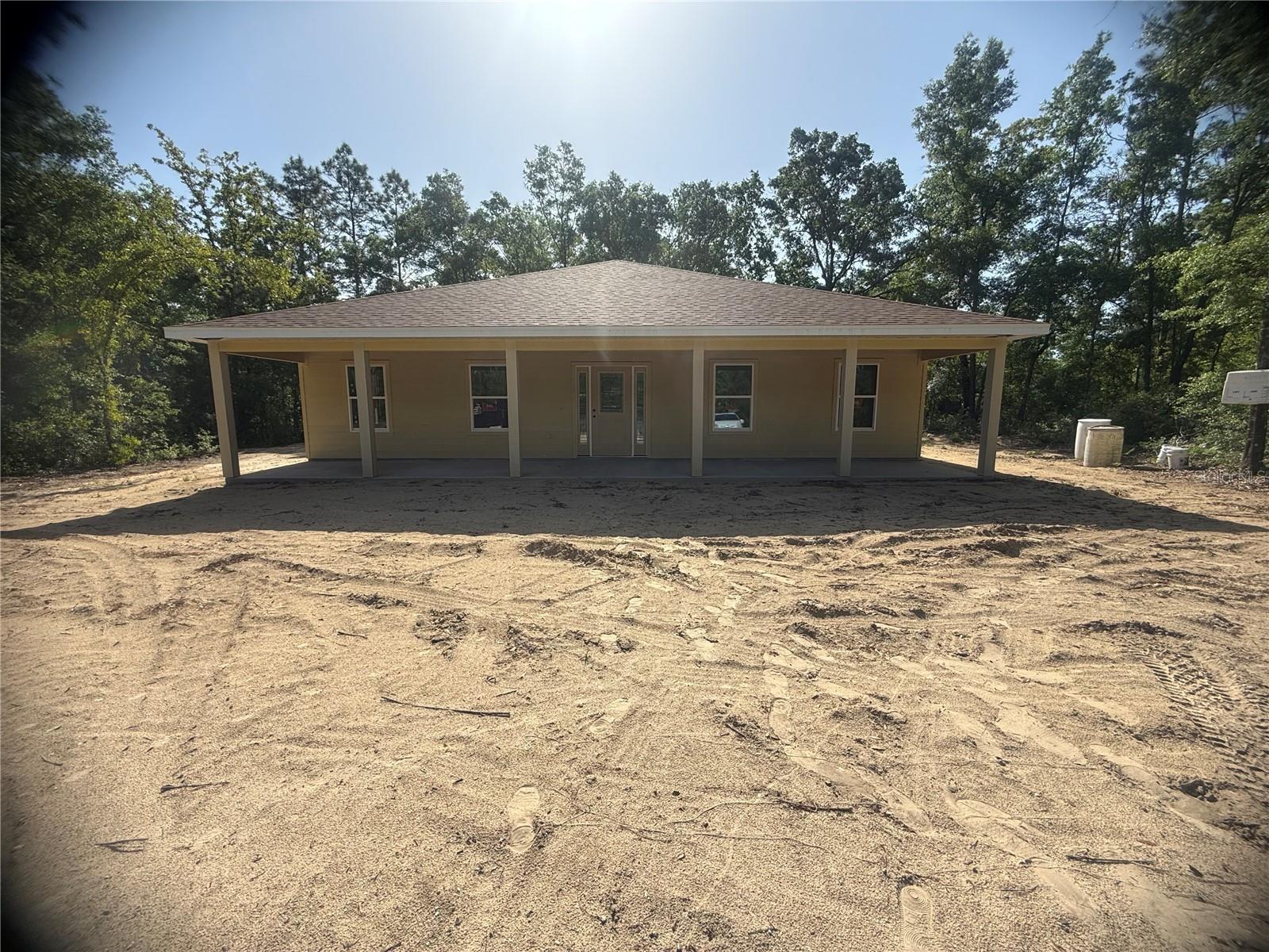 Under Construction. Brand New 2025 Construction in the Growing Williston Highlands! Welcome to this beautifully crafted 4-bedroom, 2-bathroom custom home, designed with modern living in mind. Nestled in a prime location, you're just 20 minutes from Gainesville and 30 minutes from both Ocala and the World Equestrian Center—offering small-town charm with quick access to big-city amenities. Step inside to an open, airy floor plan filled with natural light and upscale finishes throughout. The spacious great room flows effortlessly into the dining area and gourmet kitchen, making this the perfect space for entertaining. The kitchen features high-end appliances, stylish fixtures, and premium finishes carefully selected by professional designers for both beauty and easy maintenance. This home boasts a desirable split-bedroom layout with vaulted ceilings in the main living space. The luxurious master suite is a peaceful retreat, complete with a massive walk-in closet, large windows, and a spa-style bathroom featuring dual vanities and a custom walk-in shower with luxury ceramic tile. The additional bedrooms are generously sized with privacy on the opposite side of the home. A fourth bedroom provides flexibility as a guest room, office, or flex space. There's also a full indoor laundry room with extra storage for convenience. Step outside to your oversized covered patio—ideal for relaxing or entertaining while enjoying the tranquil backyard views. Additional features include durable and stylish waterproof vinyl plank flooring throughout (NO carpet!), double-pane windows, ceiling fans, and more. Set on the peaceful outskirts of Williston, this home provides the perfect balance of quiet living with easy access to Gainesville, Ocala, and Florida’s scenic Nature Coast. Don’t miss your chance to own this exceptional new construction home—schedule your tour today!
