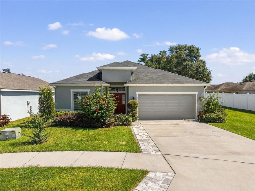 Do not miss this stunning home with amazing bonuses! When you pull up to the home, you will notice the lot is oversized. It rests up against HOA owned (and maintained) property that makes it feel like your back and side yards are fully extended away from the neighbors. Home has upgraded paver driveway to give you a little more room to navigate without trampling the grass. Paver patio is also in the backyard, allowing for covered space or to sit out in the sunshine. Lush landscaping gives a little extra privacy, and EV charging station brings the modern touch. Inside the entryway is fully tiled and carries throughout the main areas of the home. Kitchen has upgraded counters and cabinets, and an ABSOLUTELY HUGE pantry. Laundry room has utility sink and butcher block counter with storage. Secondary bedrooms are all spacious with ample closet space. Bedrooms 3 and 4 share a "jack and jill" style bathroom. Open floorplan allows you to flex the space around the kitchen as you need; living room, dining room, entertaining space, and more. Primary suite can accommodate large furniture (yes, that is a "Florida King"!), and has a walk in closet. Primary bathroom has separated sinks, soaking tub, and newly remodeled shower. Solar Panels will be paid off at closing; no worry, just benefit. There are so many features in this home that are truly appreciated in person. Come see it today!