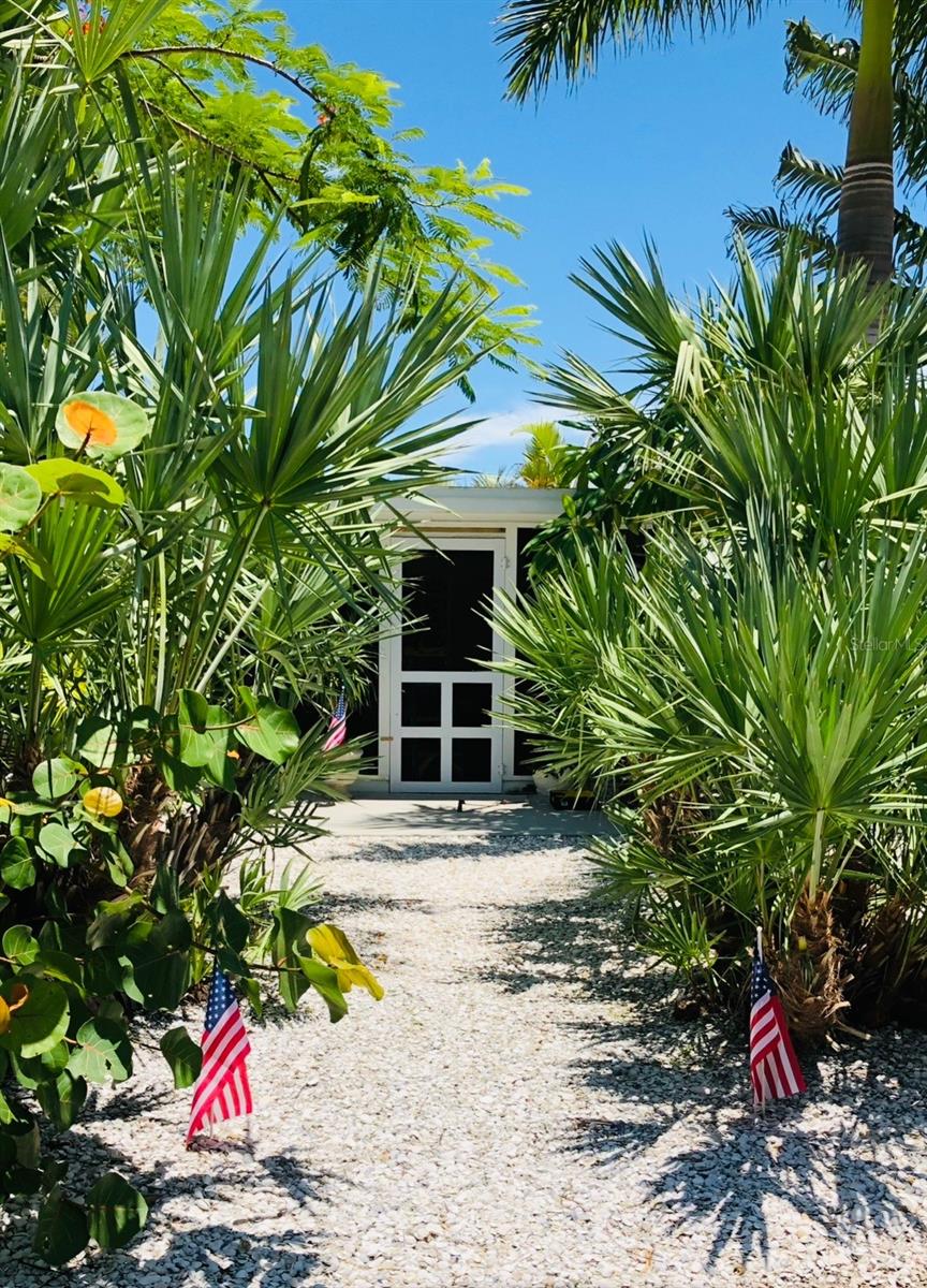 TROPICAL ALLURE! Mature tropical landscaping frames in a beautiful beach property within steps from the beach. Location makes living the BEACH LIFE easy and breezy!!!