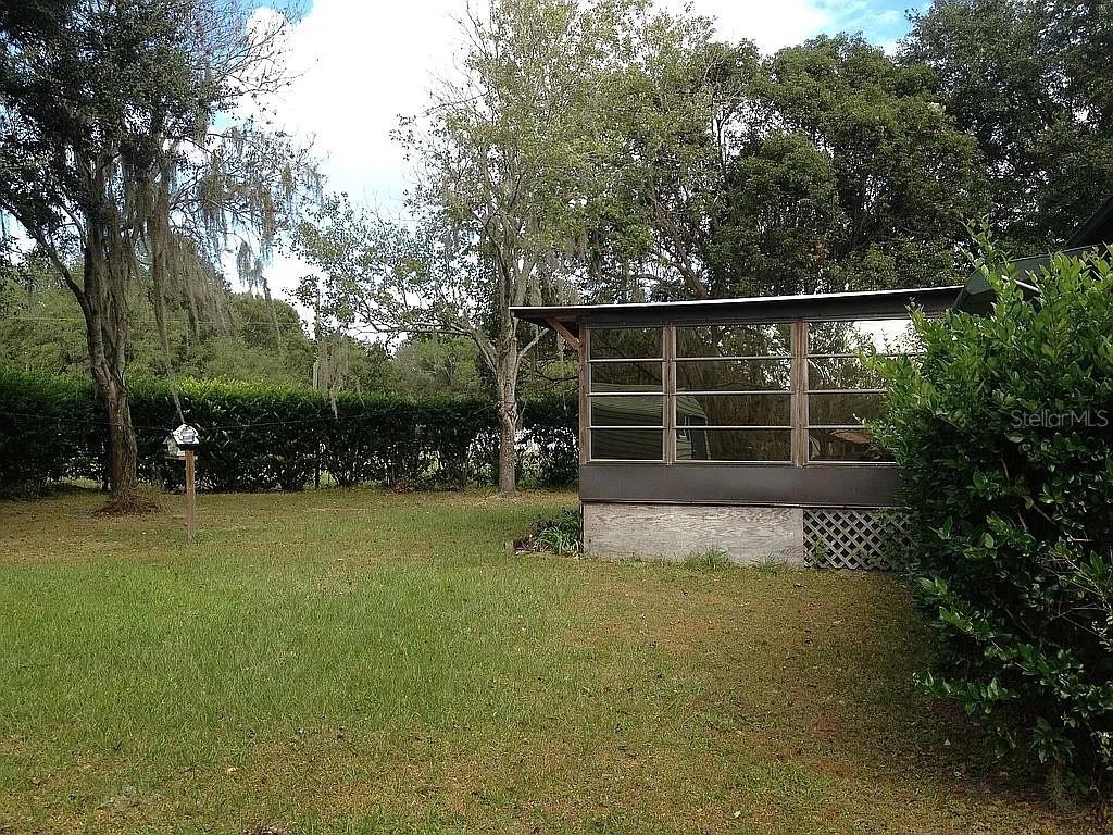 Beautiful property located in Polk city. A quiet and cozy place that features 5+ acres (completely fenced, and high and dry). There is enough space for farm animals. You can live the country lifestyle, yet you're only a ten-minute drive to I-4, and just minutes from the theme parks. The house has a front and back porch, the large front porch is enclosed with glass windows and is partially insulated (roof) primarily used as a pseudo extension of the living room while the back porch has a ½ bath (shower, sink, toilet). Come see this diamond in the rough!