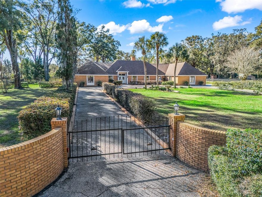 Welcome to your private mini-farm retreat just minutes from the Florida Horse Park.  Set on 3.41 beautifully maintained acres, this updated 4-bedroom, 3.5-bath pool home blends modern comfort with equestrian functionality.  The home has been freshly painted and features recessed lighting throughout, creating a bright, inviting atmosphere. At the heart of the home is a chef’s kitchen showcasing custom cabinetry, quartz countertops, and a gas range—perfect for both everyday living and entertaining. A new roof in 2024 adds peace of mind. Step outside to your resort-style saltwater pool, complete with an attached shallow kiddie pool—ideal for relaxing afternoons and family fun. Equestrians will appreciate the well-designed 3-stall barn, featuring mats and individual walkouts from each stall. The property offers convenient back-gate access to a public easement, providing direct opportunities for hacking your horse right from home.  All of this is tucked away in a peaceful setting, yet just minutes from world-class equestrian venues, trails, and events. This is a rare opportunity to enjoy refined country living with everything a horse property needs—without sacrificing convenience.
