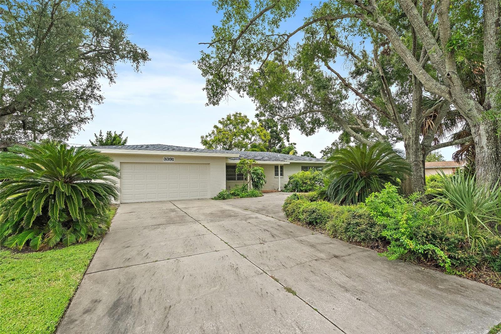 Welcome to 3391 Walnut St NE, a beautifully maintained Florida Ranch in one of St. Petersburg’s most desirable neighborhoods! Built in 1959, this spacious home offers 2 bedrooms, 2 bathrooms, and a versatile den with closet that can serve as a home office, guest room, or hobby space. The primary suite is generously sized and features a large closet, en-suite bath, and a private sitting area perfect for reading or working from home. The second bedroom also includes two oversized closets. Throughout the home, you’ll find original terrazzo and brick floors. The open living, dining, and kitchen areas are filled with natural light from abundant windows, creating a bright and welcoming atmosphere. An inside laundry room and brand-new appliances add extra convenience. Set on nearly one-third of an acre, this corner lot offers a circular driveway, two-car garage, tropical landscaping, and a fully fenced yard. The backyard and patio provide the perfect outdoor retreat for grilling, entertaining, or enjoying the Florida sunshine. Ample storage and closet space make this home as functional as it is charming. The location is unbeatable—nestled between the Vinoy Golf Course and Smacks Bayou, and only two blocks from Crisp Park, where you’ll enjoy a playground, picnic pavilion, exercise equipment, and dual boat ramps with direct access to Tampa Bay. The NorthEast Park Placido Shores/Snell Isle area is private, quiet, and highly sought after, while still being minutes from downtown St. Petersburg, The Vinoy, world-class beaches, shopping, dining, Tampa, and international airports. Freshly painted and move-in ready, this home offers peace of mind and the opportunity to own in one of the most desirable parts of the city. Don’t miss out on this hidden gem—schedule your private showing today!