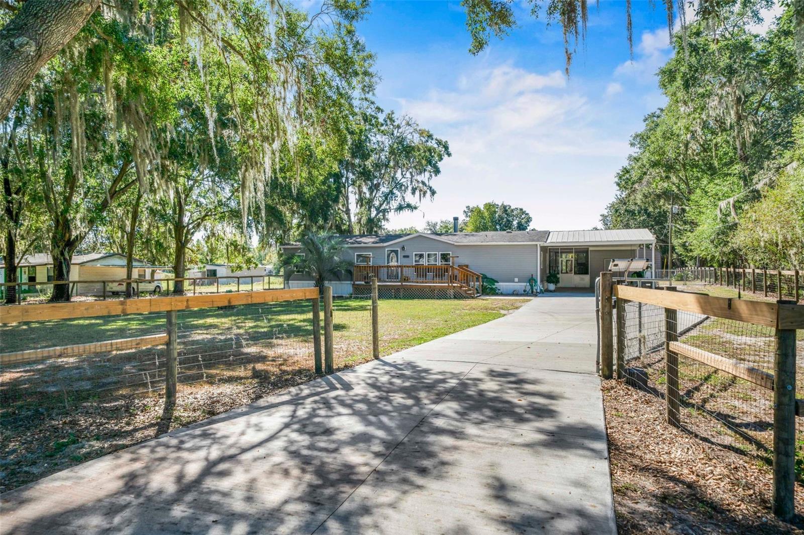 Don't Miss this Rare Opportunity! Move Right In Ready. This Beautifully Renovated 3 bed,2 bath Pool Home, Nestled on over an Acre of Fenced-in land, while enjoying Lake Rousseau views! Step outside and Enjoy your Peaceful Oasis featuring a Sparkling Inground Pool; Heated, Screened-in Enclosure, Salt System. Other Amazing Features include: 20 x 30 Outbuilding, New Water Heater with "Smart System", New LVP flooring, New Concrete driveway, 2 car Carport with workshop, Engineer Report, Pool Enclosure Rescreened, Mini-split HVAC in home for additional energy efficiency. Newer and Updated: Windows and Doors, Duct work, Insulation, Vinyl Siding and Skirting, Gutters w/leaf guards, Drain field and Septic lid, Dishwasher, Reverse Osmosis, Water Softener System. If furniture and John Deere are needed Seller may be sell.
