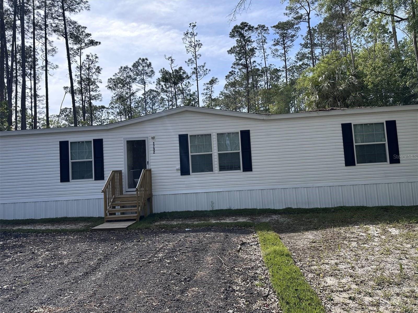 This brand new, never lived in Champion Prime home in Daytona North (Bunnell) is ready for move in, as CO has already been issued! No waiting! Bring the whole family to this spacious, open floorplan 4/2 manufactured home featuring over 1,800 sq ft of living area, a split bedroom floorplan, spacious bedrooms (most with a walk-in closet), dual sink vanity in the master bathroom, and a large kitchen island, all sitting on a 1.14 acre lot, in an X flood zone. Brand new everything; well, septic, appliances, roof, AC, you name it! This one is a must see at a great price.