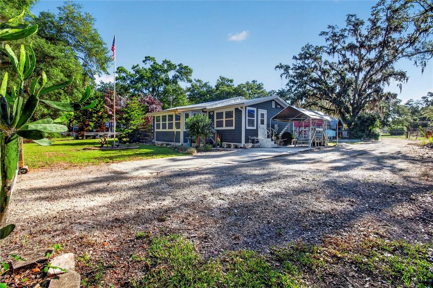 Can easily be converted back into a 2 bedroom home. Roof: 2017 HVAC: 2017 Water Heater: 2016 Escape the noise and step into a lifestyle defined by space, privacy, and fresh country air—while still enjoying easy access to everything you need. Nestled on nearly 3 acres, this unique property offers the perfect blend of peaceful rural living and everyday convenience, just a short drive from Tampa, major highways, shopping, dining, and top employers .
Surrounded by mature trees, open skies, and natural beauty, the setting invites you to slow down and enjoy life outdoors—whether it’s morning coffee under the shade, evenings by the gazebo, or simply taking in the quiet. The expansive, fenced land features multiple pastures and a picturesque creek, creating a serene environment with room to grow, garden, or explore new hobbies .
The home itself is thoughtfully updated and designed for comfortable, easy living, with an open layout, a bright sunroom, and a spacious primary suite. The kitchen stands out with quality finishes and generous workspace, ideal for gathering and everyday living .
Additional structures - including workshop space, storage buildings, and covered parking—offer flexibility for projects, equipment, or creative pursuits. Whether you’re seeking a quiet retreat, space to spread out, or a property with room to adapt to your lifestyle, this one delivers.
Experience the calm of country living where you can unwind, breathe deeper, and still be just minutes from the conveniences that matter.