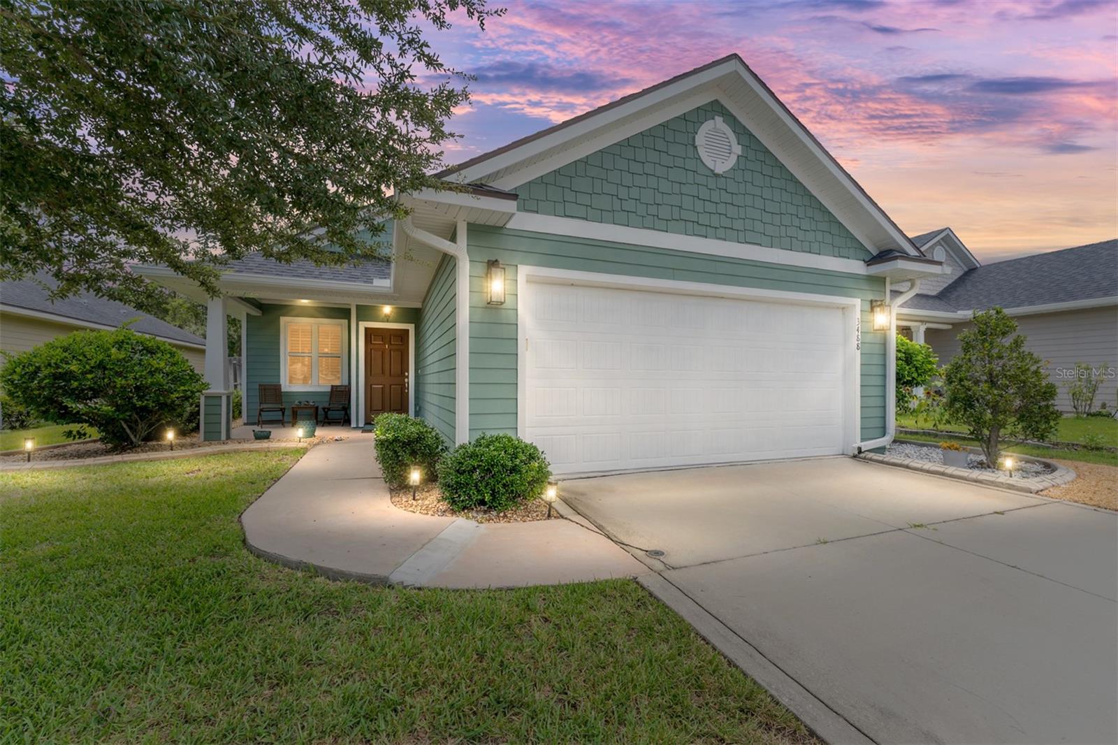 Refined elegance meets everyday comfort in this beautifully maintained single-family residence, quietly positioned within the sought-after Fletcher Oaks community, offered with a stunning 2.75 assumable FHA loan available to qualified buyers. With a current total monthly payment of just $1,997.93, this opportunity could save hundreds of thousands over the life of the loan. Built in 2016 and offering nearly 2,000 square feet of intentional living space, the home is defined by classy architectural details, abundant natural light, and a layout designed for both connection and calm. Curb appeal is immediate, with newer exterior paint and a charming front walk that leads to a covered porch—an ideal spot for observing the quiet rhythm of this welcoming neighborhood. Inside, timeless elements such as crown moulding, chair rail accents, and wainscoting add visual interest, while wide plank wood and tile flooring flow seamlessly throughout the main living areas. A spacious living room with coffered tray ceiling anchors the open-concept floor plan, which continues into a chandelier-lit dining area and a sun-filled kitchen. Solid wood cabinetry, stone countertops, stainless steel appliances, and a skylight combine to create a space that is both functional and elegant. A two-tier bar counter offers versatility for meal prep, casual dining, or conversation. Three generously sized bedrooms provide flexibility, each featuring hardwood flooring and ample closet space. The primary suite serves as a true retreat, complete with a walk-in closet and a luxurious en-suite bath with dual vanities, a walk-in shower, and a deep soaking tub. A second well-appointed bathroom accommodates the additional bedrooms with equal attention to detail. Outdoor living is effortless with a screened patio, covered front porch, and a fully fenced, low-maintenance yard supported by a smart irrigation system. The addition of financed solar panels enhances the home’s energy efficiency, offering meaningful savings on monthly utility costs while supporting sustainable living. Additional highlights include a 2-car garage and access to top-rated schools including Glen Springs Elementary, Westwood Middle, and Gainesville High. Set along a peaceful street with sidewalks and a strong sense of community—and just minutes from shopping, dining, parks, and downtown Gainesville—this home offers a rare blend of style, savings, and lifestyle.