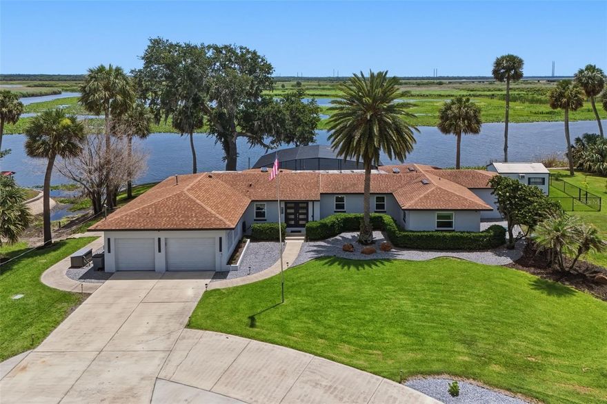 This is a once-in-a-lifetime opportunity to own a one-of-a-kind riverfront home.  Set on a sprawling .81 acres of land and sitting on a quiet private road in the established waterfront community of Indian Mound Village, this beautifully updated riverfront pool home offers the rare combination of modern upgrades, flexible living space, and true Florida outdoor living. Positioned along a protected no-wake slough off the St. Johns River, the property offers a peaceful waterfront setting where manatees, birds, and native wildlife are part of everyday life. A floating dock and rare private boat slip provide effortless access to the water while offering the protection and serenity that make this setting so unique.  Inside, nearly every major system and finish has been thoughtfully updated in recent years, creating a move-in-ready home that blends comfort, style, and peace of mind. Outside, you can enjoy the comforts of your spacious lanai where you can dine and take in the stunning views or take a refreshing dip in the sparkling pool. The custom kitchen is outfitted with premium Jenn-Air appliances, Schrock cabinetry with rollout storage, quartz countertops and backsplash, pot filler, touch-activated faucet, warming drawer, under-counter ice maker, and refrigerator drawers, designed for both everyday living and entertaining.  The home features 3.5 bathrooms, including three ensuite bedrooms that serve as private retreats, with renovated tile, vanities, and fixtures, along with updated flooring, trim, interior doors, custom closet systems, and motorized shades throughout the main living spaces.  Major infrastructure improvements include impact-rated double-pane windows, a whole-home generator with propane tank, updated crawlspace encapsulation system, water purification system, upgraded electrical systems, newer roof, resurfaced pool deck, and more, offering a level of maintenance and investment rarely found in homes of this era.  Beyond the main residence, the air-conditioned detached shed with dedicated internet and power creates the perfect flex space for a home office, studio, gym, workshop, or guest overflow.  This is a prime location just minutes from downtown Sanford, Lake Monroe Riverwalk, I-4, HWY 417, and SunRail for effortless commuting. Offering the privacy and character of one of the area's most unique neighborhoods, 921 Powhatan Drive is a rare opportunity for buyers seeking updated waterfront living with space, privacy, and long-term value.