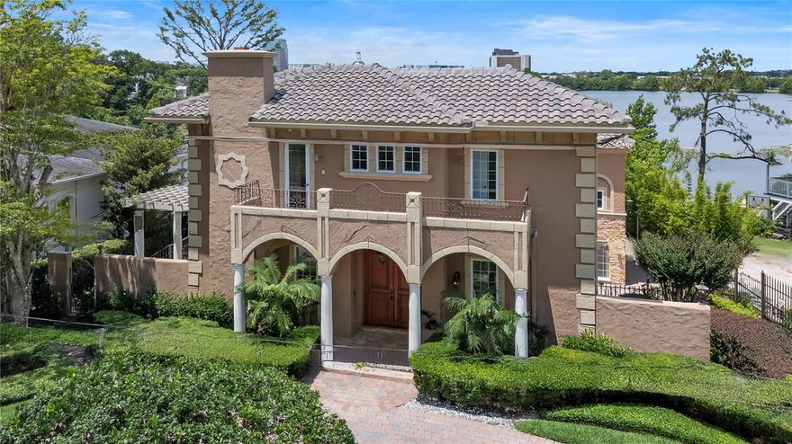 Stunning Lakeside Estate! A timeless Mediterranean gracefully set on the sparkling shores of Lake Highland in downtown Orlando. This stunning 4-bedroom, 4.5-bathroom residence with approximately 5,300 sq. ft. includes a private in-law suite with a secondary kitchen, a 2-car side-entry garage, and unmatched lakefront views—just steps from Lake Highland Prep and minutes from the vibrant downtown and Winter Park lifestyle.

From the moment you arrive, the circular driveway and classic architecture invite you into a world of elegance and comfort. Inside, an open floor plan unfolds with soaring vaulted ceilings, lakeside vistas, and multiple indoor and outdoor living spaces designed to impress.

The main floor features both a spacious master suite with walk-in closet, spacious primary bathroom with soaking tub and separate shower. There is an additional secondary bedroom suite, offering flexible living options on the main floor. A formal living room and elegant dining room with a has fireplace set the tone for sophisticated entertaining, with French doors leading out to a side terrace. A private den provides a quiet retreat or home office. A half bath adds convenience for guests.

The heart of the home is a gourmet kitchen, perfect for the culinary enthusiast, opening to family gathering areas and sun-drenched lake views. Upstairs, you'll find two bedrooms, an open study area. The lower level boasts a huge bonus room and addiontal media, ideal for movie nights and hosting friends and family. There is a a kitchenette and full bathroom on the lower level as well. Making it easy to convert to an in-law suite with private entrance.

Step outside to multi-level outdoor living spaces including an infinity-edge pool, private dock, and expansive terraces designed to showcase the home’s spectacular sunset views over the lake. Lake Highland is a 33 acre private ski lake.

House was completed re-built in 2003 and an addition in 2008. Recent upgrades include a new $100,000 barrel tile roof, two newer AC systems, and fresh exterior paint—offering peace of mind and lasting beauty. Newly refinished Brazilian Hardwood floors and newly polished marble throughout. Updated designer lighting and fans

This rare estate is more than a home; it's a lifestyle defined by luxury, convenience, and the tranquility of lakefront living.
