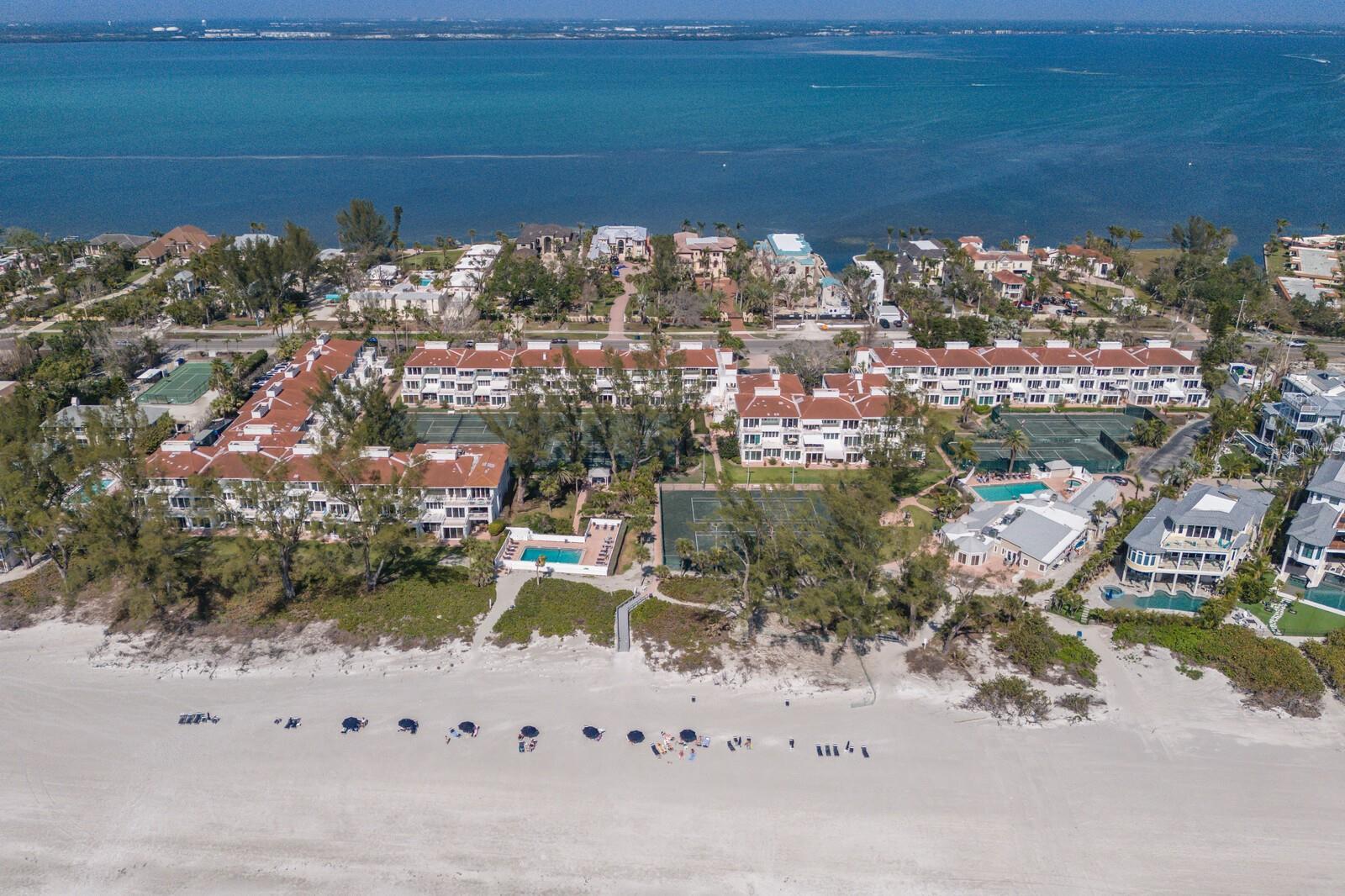 Luxury turnkey furnished beach condominium in the sought-after resort-style Club Longboat Beach and Tennis community. Near the beautiful sandy beaches on the Gulf, experience captivating sunsets from Longboat Key’s 10-mile sugary sandy beaches with your own private beach access. Imagine waking up to lush, pristine landscaping, tropical sea oats, and sparkling blue Gulf waters with the sound of crashing waves providing you with peace and serenity. This amazing community also offers the best tennis courts on the Island, with 8 Har-Tru Tennis courts, lights for night play, a dedicated tennis pro and a ball machine to allow you hours of practice to perfect your tennis game. This move-in ready fully furnished 1,624-square-foot two-bedroom, two bath unit provides an open kitchen, spacious living room with adjacent private balcony with partial water views, an integrated dining room, a bonus room and interior laundry room. Enjoy comfort and style accented with exquisite décor and custom furnishings, the home is outfitted with real wood floors, hurricane-impact windows, plantation shutter sliders, two living areas, one could be converted into a third bedroom or office, and two balconies of 140 square feet each of outside living area. The primary bedroom has an en-suite bath, king-size bed, dual custom built closets and a private balcony to enjoy your morning coffee. The guest bedroom you will find cozy with a double-size bed. The kitchen offers plenty of cabinet space, granite counters plus a wine cooler. This spotless home is well maintained, has tons of storage including an outdoor storage closet for your beach toys, covered parking for one car and plenty of parking for guests. On the second floor, the unit is accessible by elevator or stairs. Club Longboat Beach and Tennis community offers amazing amenities, including private beach access with lounge chairs and beach umbrellas, tennis, pickleball, fitness center, shuffleboard, barbeque area, clubhouse with regular social events, sauna, spa and two heated swimming pools. Club Longboat has 85 well-managed units and is a pet-friendly community allowing up to two pets. The condominium fees include exterior maintenance and insurance, cable, water, sewer and trash. Make it your home or a rental property. The minimum lease is one month and can be rented up to 12 times per year. Only a short drive to many fine restaurants, shops, Anna Maria Island, St. Armands Circle and the City of Sarasota. Sarasota is a well-known center for arts and culture including the Asolo Theater, Van Wezel Performing Arts Center and Ringling Museum. Make your appointment today to see this amazing home!