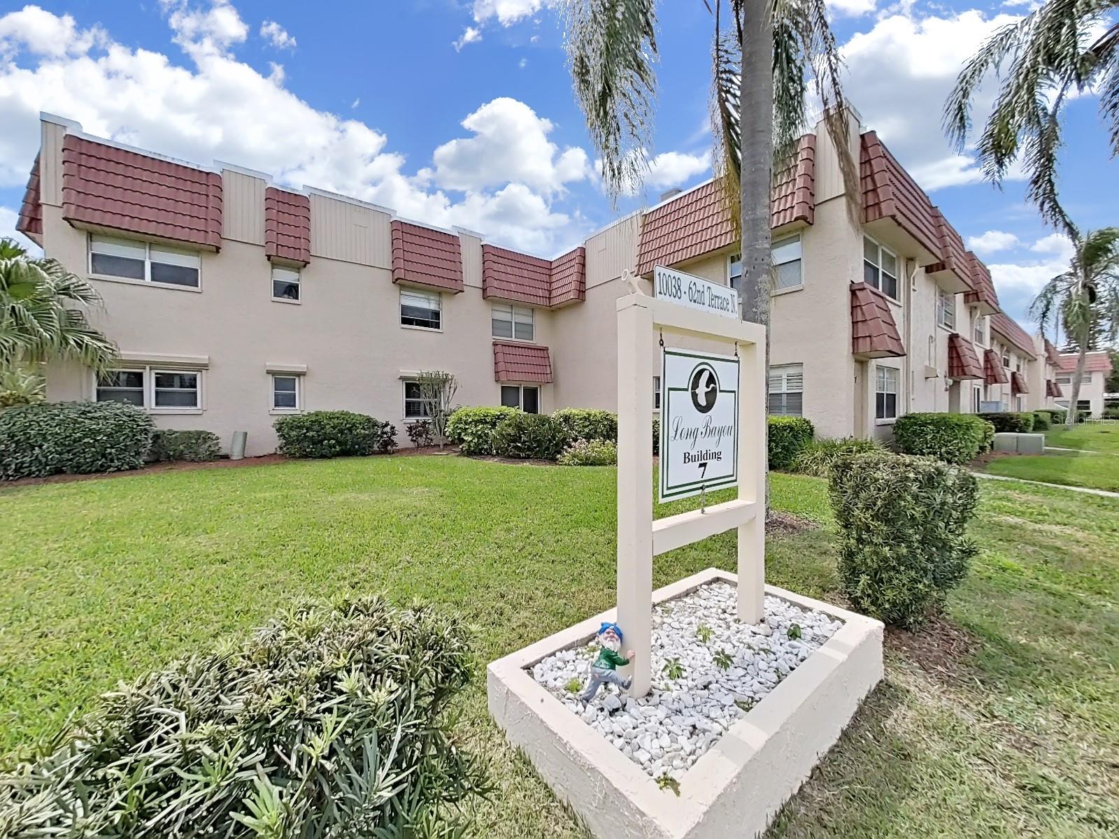 Beautiful ground floor 2/2 in Long Bayou! Spacious floor plan with rare private outdoor patio. Updated kitchen features stainless steel appliances, glistening countertops, and wood cabinetry. Split bedroom plan offers privacy for guests. Other features include luxury vinyl planking in Great Room, plantation shutters, updated baths, and a Florida room. This unit is a gem and is available partially furnished. Just a few steps and you can avail yourself to a host of amenities that will make you fall in love with a leisurely Florida lifestyle—a heated pool with locker rooms; a fitness center; and courts for tennis, pickleball, shuffleboard and bocce. The clubhouse is complete with kitchen facilities, a wood shop, auditorium, billiard and card room, a library, and a TV lounge. Long Bayou is a highly desirable, active, 55+ gated community offering nature trails and scenic water views. Centrally located close to beaches, shopping, and restaurants.