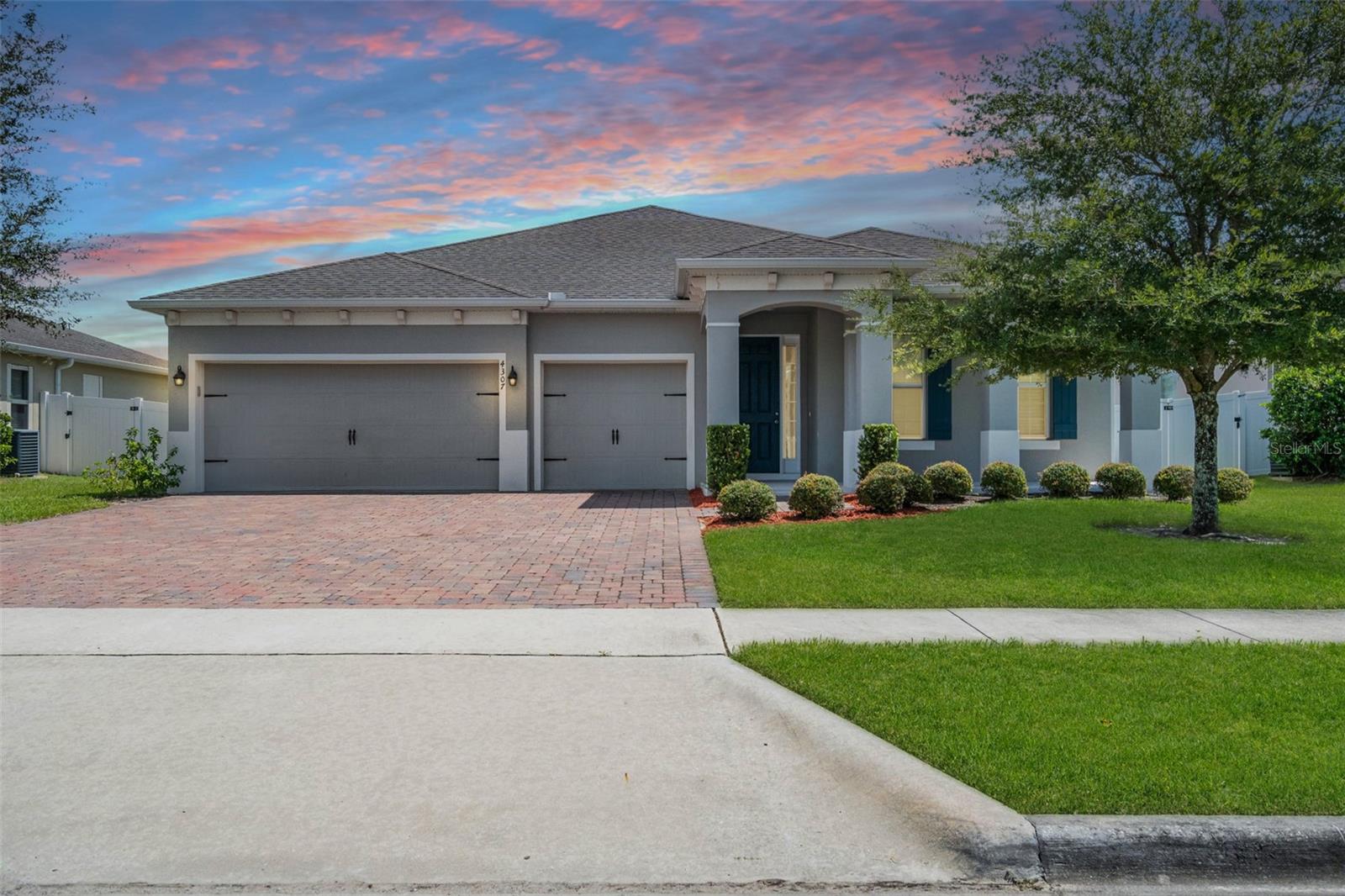 Welcome to 4307 Tigris Drive, Apopka, FL 32712—a stunning 4-bedroom, 3-bathroom home with a spacious 3-car garage that is completely move-in ready! This newer single-story residence showcases a desirable three-way split floor plan, offering two primary bedroom ensuite for both privacy and open living spaces designed for comfort and style. With impressive features like double-pane windows, a tankless gas water heater, garage door openers, a formal dining room, and a dry bar, this home blends modern convenience with elegant design. From the moment you arrive, you’ll be drawn to the inviting front porch—a perfect spot to relax and unwind. Step inside and you’ll find an interior filled with thoughtful upgrades like newly interior paint and new carpet in all bedrooms. The open layout flows beautifully across the common areas, highlighted by sleek tile flooring that adds sophistication while remaining easy to maintain. At the heart of the home is the chef’s kitchen, complete with 42” cabinets, quartz countertops, new soft-close cabinetry, and stainless-steel appliances. This kitchen is designed to impress, whether you’re preparing everyday meals or entertaining guests. The master suite serves as your private retreat, complete with a tray ceiling and a spacious design. The en-suite bathroom features dual sinks, a walk-in shower, and a large walk-in closet—perfectly combining style and functionality. The additional bedrooms are equally impressive. Two share a full bathroom with dual sinks, quartz countertops, and a tub, while the fourth bedroom enjoys its own private bath with quartz countertops and a glass shower door. Every detail has been carefully designed to create a cohesive and modern feel throughout the home. Step outside to the expansive lanai, where you can enjoy your mornings with a cup of coffee or spend evenings dining al fresco. The oversized 3-car garage provides plenty of room for vehicles, storage, or hobbies, making it both practical and versatile. Location is key, and this property delivers. Just a short walk away, you’ll find the Northwest Recreation Complex—one of Apopka’s most popular destinations. With its lake, picnic areas, sports fields, and scenic trails, it offers endless opportunities to enjoy the Florida lifestyle right in your neighborhood. 4307 Tigris Drive is more than just a home—it’s a lifestyle. With its modern finishes, spacious layout, and prime location, this property is a rare find. Schedule your private showing today and see why it stands out as one of Apopka’s best opportunities!