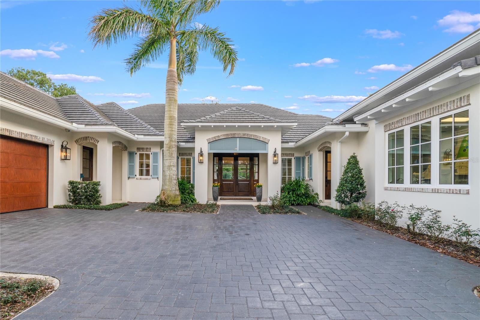 Under contract-accepting backup offers. Your dream home awaits you in the highly coveted Merritt Park neighborhood! Tucked away on a peaceful street, this home offers an oasis of tranquility in the heart of Orlando. This Coastal Traditional style home features four bedrooms, four and a half bathrooms, 4,000+ Sq. Ft. of living space with an additional 750 Sq. Ft. of air-conditioned garage, and a covered lanai, totaling 6,338 Sq. Ft. of roof covered space. As you step into the home through the custom sapele wood double doors, the impressive soaring ceilings, embellished with stunning wood beams and high-end light fixtures, will immediately capture your attention. Beautiful Antique Ebony oil-stained, European Oak flooring flows throughout the home creating a cozy transition from room to room.
The ultimate chef’s kitchen sits at the heart of the home. It features a Skara Brae Cambria Quartz kitchen island with custom waterfall legs, a Sub-Zero integrated refrigerator, and a 48” Thermador gas range that includes a 2-burner induction cooktop in addition to six gas burners and two ovens, one of which is steam convection oven that includes a warming drawer. The kitchen sink is a Kohler Stainless Steel single bowl with plenty of accessories, and the kitchen faucet is a Waterstone contemporary single lever gooseneck spout with a pull-down feature. Moreover, the kitchen workspace is equipped with a Waterstone disposal air switch, Waterstone soap dispenser, and Waterstone 1000 Ultimate hot and cold-water filtration system. The Cambria Ironsbridge Quartz backsplash beautifully merges warm and cool tones throughout space. Adjacent to the kitchen, sits the versatile butler's pantry that is perfect for storing fine china, preparing meals, or creating a wine cellar.
Escape to the resort-style master suite, a spacious haven that opens to the outdoor lounge and pool area. Enjoy the convenience of the oversized walk-in closet with custom storage and shelving. The bathroom boasts modern chandeliers, gold hardware finishes, double vanities, and a spa-like soaking tub that shares a double-sided fireplace with the feature wall in the master bedroom.
This home is perfect for individuals in need of a dedicated workspace, with a full office as well as an additional half office designed to provide ample space for productivity and organization. The offices spaced are perfectly suited for remote work, meetings, or planning, offering an ideal environment to help you work efficiently.
With motorized screens installed on the lanai, the indoor and outdoor living spaces are seamlessly connected, creating an ideal setting for entertainment. The summer kitchen is equipped with a Blaze Grilles grille and a spacious dining area. Guests can relax in the inviting lounge space around the outdoor fireplace, take a dip in the sparkling pool, or relax in the gas heated spa.
Parking is never an issue with the remarkable garage arrangement featuring a spacious 2-car garage for your everyday vehicles with electric charging station, an extra-large 750 Sq. Ft., air-conditioned garage dedicated to storing your recreational vehicles, or 2 additional cars. Adding to the convenience, a circular driveway provides ample parking space for guests or extra vehicles.
Centrally located near Downtown Winter Park, Mills 50 District, Audubon Park, East End Market, and only a seven-minute walk to picturesque Leu Gardens. Zoned for A rated schools: Audubon K-8 and Winter Park HS. Schedule your private showing today!