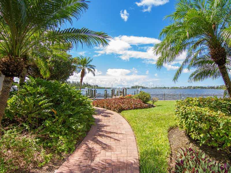 With uncompromising southern Bay views, this California mission style manse is situated on approximately 1.5 acres on one of Sarasota's favorite streets. Ultimate convenience to the mainland, this walled and gated North Siesta Key estate has lush tropical gardens providing privacy for the owner. Surrounded by the beautiful Bay waters and a side canal totaling over 403' of seawall with 2 deep water boat docks and an old fashioned boat house for small craft. Comprised of over 9,385 sq. ft of air conditioned space, the 6,837 sq. ft. Main house and 2,548 sq. ft. Guest house are connected by an interior hallway lending tremendous flexibility for a large family, multiple guests or extensive office facilities. Major renovations were performed over the years. Features include high ceilings, marble floors, light oak sold wood doors, trim and tongue-n-groove ceilings, walls of glass for endless water views, spacious rooms, a new barrel tile roof, a long approach with a circular driveway, a phenomenal private heated tropical pool and spa retreat, and a gazebo for relaxing and entertaining. 3 car garage with hurricane rated doors and additional rear garage door leading to oversized parking pad. Seize this opportunity to claim a rarified amount of land and home with arguably some of the area's best deep water boating and tremendous Bay views. This property includes parcel #2019-15-0028 bayfront lot. Lot dimensions are of non-submerged land. Square footage is both lots.