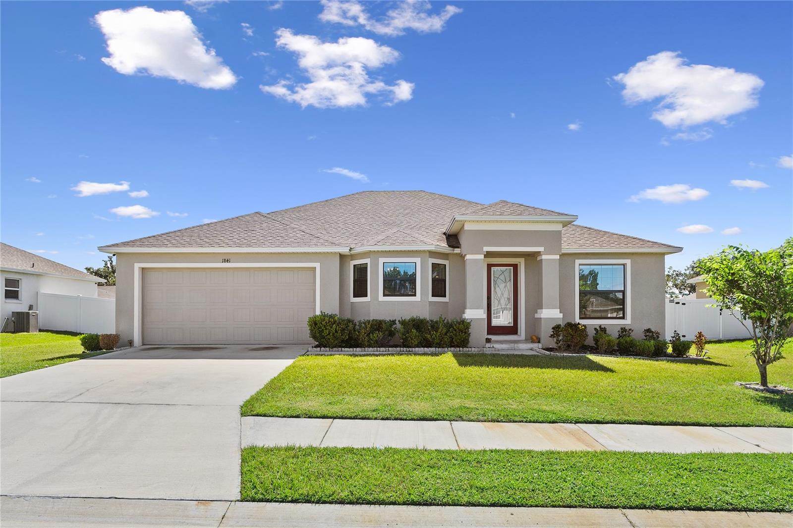 Experience the best of Lakeland living in this pristine 4-bedroom, 2-bathroom, 2-car garage home, located within a desirable gated community. Enjoy seamless access to I-4, simplifying your commute. The welcoming front porch and curb appeal enhances the home's charm. This turn-key home, thoughtfully maintained and professionally staged, features a spacious and practical design. Enjoy the comfort of plush carpeting and the resilience of luxury vinyl flooring throughout. Energy-efficient recessed lighting and ceiling fans contribute to a pleasant ambiance. The modern kitchen is equipped with stainless steel appliances, solid wood cabinets, and solid surface countertops, making meal preparation and entertaining a joy. An open-concept living and dining area provides the perfect space for creating lasting memories with loved ones. The private primary suite offers a luxurious retreat, boasting dual sinks, a walk-in shower, a relaxing garden tub, and a spacious walk-in closet. Three additional well-sized bedrooms offer flexibility to suit your needs, whether for guests, a home office, or a play space. Step outside to your screened, covered lanai and enjoy the privacy and security of a vinyl-fenced backyard, ideal for unwinding or entertaining in the fresh outdoor air. Situated for ultimate convenience, this home is just moments away from shopping, dining, and major roadways, simplifying your daily routine. Don't delay – arrange your private showing today!