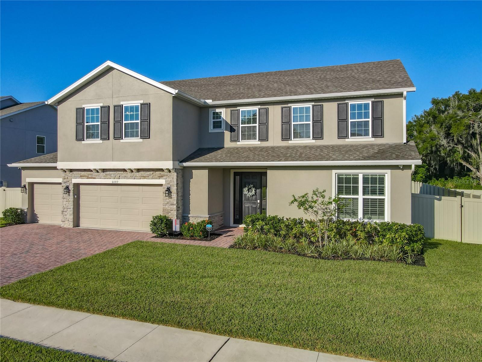 Welcome to this meticulously upgraded and stunning custom residence. Spanning approximately 3,900 square feet, this impressive home offers substantial space with five bedrooms, three full bathrooms, and one half bathroom.
The expansive main level features an open-concept living area. The Gourmet Kitchen is a chef's delight, complete with additional custom cabinetry, a Natural Gas Cooktop, Double Oven, Stainless Steel GE Dishwasher, and an elegant Farmhouse Sink. The kitchen, dinette, and Great Room flow seamlessly, creating an ideal setting for family life and entertaining. The well-designed floor plan also includes a separate downstairs office/den and a formal Dining Room. New Custom French Doors provide direct access to the rear lanai and oversized backyard.
Flooring throughout the main level is the durable and attractive Mohawk Revwood Plus laminate, which is both waterproof and steam-proof and extends up the staircase. The upstairs features a spacious second family room/playroom, five generously sized bedrooms, and three full bathrooms, including a convenient Jack-and-Jill bath. The Primary Suite serves as a private retreat, offering a spacious bedroom with an integrated sitting area and a spa-like ensuite bathroom.
Additional premium amenities include whole house quartz countertops, upgraded stain resistant carpet in the bedrooms, Plantation Shutters downstairs, a large four-car garage with new epoxy flooring, built-in cabinetry, and ceiling storage racks in the garage. The property is also generator-ready, with a natural gas stub located on the side of the house, and Security cameras have been installed around the perimeter of the home, providing full exterior coverage and peace of mind.  Enjoy all of these tasteful improvements without the inconvenience of new construction or renovations.
A comprehensive feature list is attached for your review.