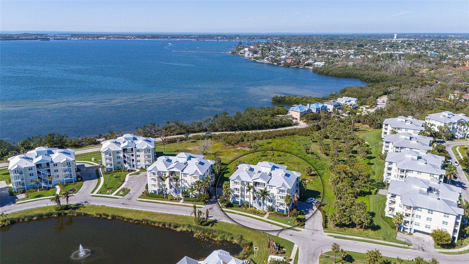 Welcome home to coastal living! Live like you’re on vacation in the gated, Key West-styled resort community of Palma Sola Bay Club. Three bedrooms, two full baths, and one half bath with 1857 square feet of living space. Built in 2020. Upgrades throughout including French doors to your private balcony in the living room and primary bedroom, high ceilings, crown molding, granite countertops and solid wood cabinets in the kitchen and baths. A breakfast island is featured in this beautiful kitchen. The owner’s suite has a large walk-in closet and French doors opening out to the private balcony The bath features dual vanities, soaking tub and standalone shower. The guest bedroom has an adjacent bath for your guests. The home features a third spacious bedroom. The half bath is large and conveniently in the hallway, easily accessible from the main living area. The dining room living room combination is spacious with plenty of windows to let in the light. Two assigned under-building parking spaces are conveniently near the elevator. Palma Sola Bay Club is just off the beautiful Palma Sola Bay in West Bradenton, minutes from the sandy beaches of the Gulf to the west, the culture, fine dining, entertainment and golf courses to the east. Within the community, there are 30 acres of protected preservation land, two charming lakes, tropical resort landscaping, a dog park and an observation deck with kayak launch with stunning views of Palma Sola Bay. The two-story clubhouse in the heart of the community boasts a fitness center, billiards table, social room and two kitchens for entertainment. Outside enjoy a heated pool with an expanded deck for lounging, fire pit, bocce court and outdoor entertainment space complete with a wet bar and gas grill. Also enjoy regular social events, including barbecues, holiday parties and casual get-togethers at our clubhouse, thereby fostering a warm and close-knit atmosphere. Flood insurance included in HOA fees. See for yourself what makes Palma Sola Bay Club an award-winning community year after year.