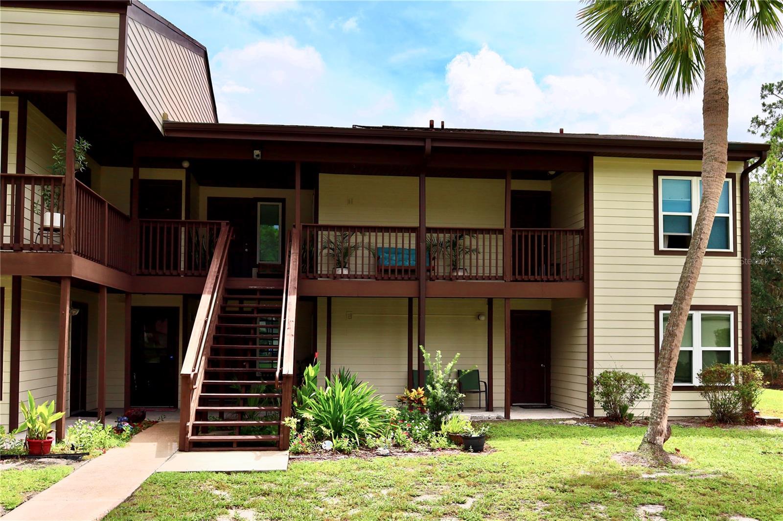 Welcome to 21204 Sandalwood Drive in Wildwood, FL. This beautifully renovated 2-bedroom, 2-bath second-floor condo combines modern comfort with serene pondside living. Offering 1,100 sq. ft. of thoughtfully designed space, this residence is the perfect blend of elegance, convenience, and lifestyle. Step onto the charming front porch and into a light-filled interior where every detail has been refreshed. INVESTORS listen up, this apartment has 2 main entrances, one located on the main foyer and the second on the guest and guest bathroom side of the property. The spacious living room showcases breathtaking pond views, creating a tranquil retreat for both relaxation and entertaining. The galley-style kitchen comes fully equipped with all major appliances, efficient cabinetry, and seamless flow into the dining and living areas, making hosting effortless. Both bedrooms are generously sized, while the updated bathrooms feature modern, stylish finishes for a touch of luxury. The home is being offered partially furnished, including appliances and select décor, making it truly move-in ready.
Beyond the property itself, the location is unmatched at just 5 minutes from The Villages, where you’ll enjoy world-class dining, entertainment, shopping, golf cart rides, and endless amenities. Whether you’re seeking a primary residence, seasonal escape, or a smart investment, this condo is the perfect choice. Don’t miss the opportunity to own this elegant retreat in the heart of Wildwood. Schedule your private showing today.