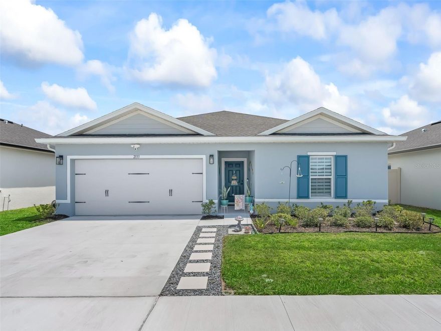 Practically new and thoughtfully enhanced, this 2025-built home offers the rare advantage of new construction quality without the added expense, time, and effort of completing upgrades yourself. Located in the desirable Sumter Villas community, residents enjoy a low HOA, community pool, and sidewalks—all without the burden of a CDD, keeping monthly costs more affordable than other nearby neighborhoods. Built by Ryan Homes and no longer available new in this community, this Mahogany model is rated as "above average" quality in county record and sits on a larger homesite with a peaceful retention pond view and a uniquely private backyard—fully enclosed with a 6-ft vinyl fence and bordered by single-story homes with no rear neighbors. This home is in pristine condition with significant improvements—upgrades that new construction typically leaves to the buyer. Exterior improvements including the fence, a screened lanai with patio lighting, 'permanent' outdoor lighting, custom stepping stone walkway along driveway, manicured landscaping, and rain gutters. Inside, the home features a warm, neutral design with abundant natural light and a cohesive, upgraded finish throughout. Tile flooring spans the entire house, complemented by added recessed lighting in the main living space, upgraded fixtures, and fan kits in all major spaces. The kitchen showcases staggered cabinetry with custom hardware, granite countertops, and a clean, modern layout. Both bathrooms are elevated with quartz counters, square sinks, custom hardware, and a custom glass shower door in the primary suite. Additional enhancements include window treatments, an insulated garage door, and a finished garage with painted walls—details that further separate this home from standard builder-grade offerings. Ideally located just minutes from The Villages and Middleton, this home provides convenient proximity to top-rated charter schools, expanding employment opportunities, shopping, dining, and medical facilities. With continued growth in the surrounding area, this location offers both immediate lifestyle benefits and long-term appeal.Skip the build process and move right into a well built home where the upgrades are already complete and the value is clear.