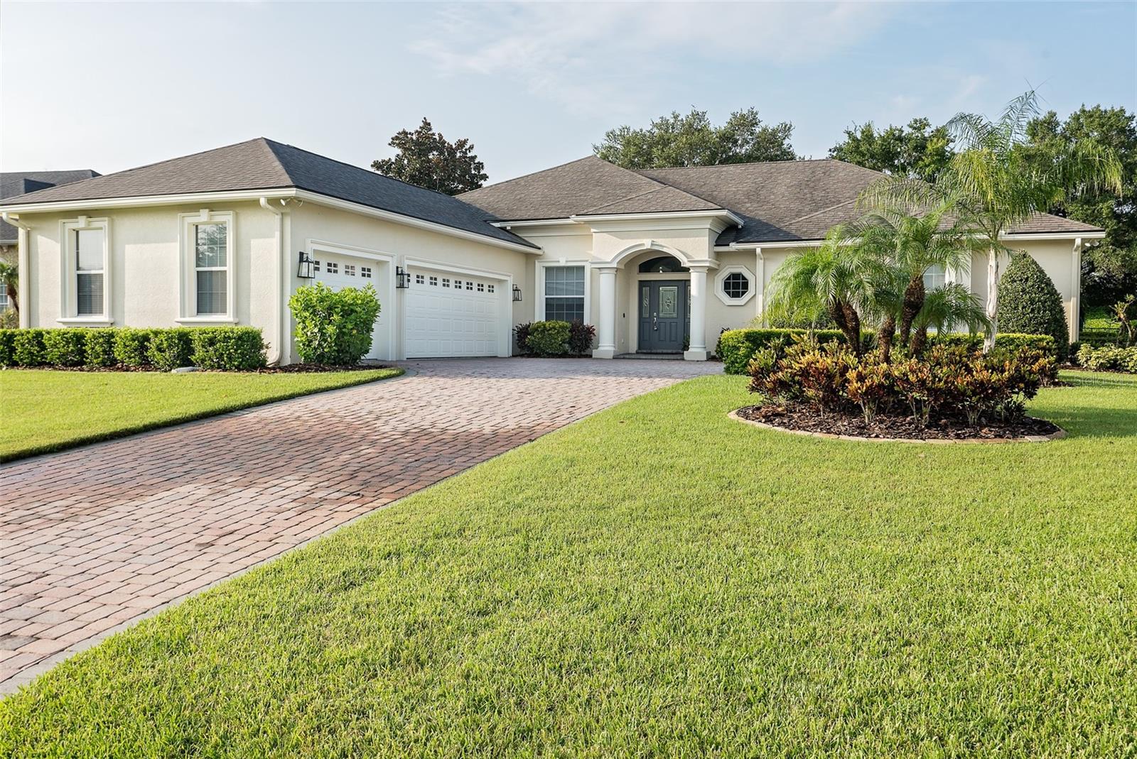You must see this stunning, recently renovated, Olivera custom-built home in Summerfield, a gated part of the Oakbridge Community. Upon entering the home, you will be impressed with Open Concept Living. The impressive open floor plan boasts high, double tray ceilings, creating a bright and airy space. The living, dining, and kitchen areas flow together, anchored by a stunning feature wall with a stone fireplace, 75” TV, and an electric insert. Elegant laminate vinyl plank (LVP) flooring spans the entire home, providing a seamless, high-end look. **Updated Kitchen:** Completely remodeled, the kitchen provides excellent storage and functionality and shines with new soft close cabinets, sleek quartz countertops, subway tile, and stainless steel appliances. It's a chef’s dream, open to the living area for easy entertaining. - **Primary Suite:** The generously sized primary bedroom features two walk-in closets and a built-in desk area. The luxurious en-suite bathroom spans 12’ x 12’ and includes abundant built-in storage, a separate water closet, a linen closet, and a cozy bench seat under a large window with additional storage beneath**Triple Split Floorplan:** Each of the three spacious bedrooms (Primary Bedroom, Oversized Bedroom 2 & Bedroom 3) offers the privacy of an en-suite bathroom and walk in closets. **Outdoor Living:** The large screened-in back patio overlooks a meticulously landscaped, fenced backyard, offering the perfect private retreat. - **Additional Amenities:** A three-car garage and a paver driveway provide ample parking, while lush landscaping enhances the curb appeal. **Additional Recent Improvements: ** New Roof (2022), Interior and Exterior Paint, updated half bathroom, washer, dryer, HVAC compressor, and lighting upgrades. The gated neighborhood of Oak Park/Summerfield ties beautifully into the Oakbridge neighborhood where you can enjoy paved walkways, established trees and manicured landscaping, providing easy access to the nearby Publix Shopping Center and Watson Clinic Enjoy the convenience of being close to shopping (Lakeside Village, Publix, Target), medical facilities, and easy access to the Polk Parkway (State Road 570), making Interstate 4 easily accessible. Experience the perfect blend of comfort, privacy, and convenience in this spectacular home. Schedule your showing today!