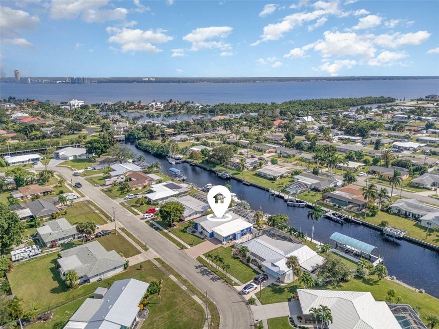 DISCOVER THE WATERFRONT LIFESTYLE YOU’VE BEEN DREAMING OF. Nestled in a classic Florida setting, this beautifully updated home is all about effortless living on the water. With direct sailboat access—no bridges, no locks—you can step onto your captain’s walk dock, lower your cantilever lift, and be on the Caloosahatchee River or out to the Gulf within minutes. A floating kayak dock makes spontaneous paddling even easier.

Inside, the home unfolds into a bright, coastal-inspired retreat where south-facing sunshine and soft breezes create a light and uplifting atmosphere. The open layout is ideal for entertaining, connecting the elegant, newly renovated kitchen to the family room and out to the pool and waterfront views beyond. The kitchen features sleek shaker cabinetry, quartz countertops, deep soft-close drawers, a stylish backsplash, and abundant storage. A spacious Butler’s Pantry—with additional cabinetry, workspace, and a wine cooler—elevates both daily living and hosting.

Wake up to water views in the generous primary suite with direct lanai access, a sophisticated ensuite bath, and a custom walk-in closet. Two additional bedrooms share an updated full bath, perfect for family or guests.

Step outside to your own private outdoor oasis. The screened lanai offers multiple areas for lounging and dining, all centered around the 2020 remodeled saltwater pool featuring a sun shelf, resurfaced interior, and travertine paver deck. Whether you’re relaxing poolside, enjoying sunset drinks on the dock, or heading out for a day on the water, this home encourages a lifestyle rooted in relaxation, recreation, and connection to nature.

Additional perks include a 2020 metal roof, cedar outdoor ceilings, 2020 double-pane windows and doors, new blinds, a 50-amp RV hookup, fresh interior/exterior paint, a fenced yard with dual gates, and Kevlar hurricane panels for full-home protection.

Located in peaceful Waterway Estates, a boating and lifestyle-friendly community with no HOA, this property is perfect for full-time living, a vacation getaway, or an income-producing investment. Close to beaches, shopping, dining, golf, and all the outdoor adventures southwest Florida offers, this one-of-a-kind home lets you live every day like you’re on vacation.

(Note: Bonus room referenced in listing is the Butler’s Pantry.)