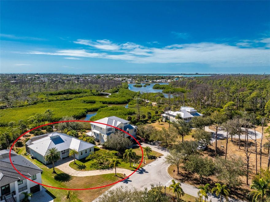 Tucked away where most people don’t even know to look, Hidden Waters lives up to its name. Set within a gated enclave of just 19 homesites, this private waterfront retreat is surrounded by HUNDREDS OF ACRES OF PROTECTED LAND, offering a rare blend of luxury, privacy, and direct access to nature that simply can’t be recreated. Step outside and you’re immediately connected to two major parks—Cedar Point Environmental and Ann & Chuck Dever Regional—linked by miles of walking, biking, and boardwalk trails starting right within the neighborhood. For those who live best on the water, a PRIVATE 30’ DOCK provides effortless shallow boat, kayaking and paddleboard access through winding mangroves channels of Oyster Creek out to Lemon Bay, the Intracoastal Waterway, and the Gulf beyond. Spend mornings cruising with manatees, afternoons fishing the backwaters, or bike to the nearby recreation center and local amenities including pickleball courts, playgrounds, splash pad, dog park and more! Larger boats are easily accommodated at nearby full-service marinas with a neighborhood day dock close by. BUILT WITH INTENTION IN 2015 and lovingly maintained, the home blends coastal architecture with modern functionality and can be negotiated TURN-KEY FURNISHED! For your peace of mind—this home features an ELEVATED living level, hurricane-rated IMPACT GLASS WINDOWS AND SLIDERS, a whole-house surge protector and a 2023 STANDING SEAM METAL ROOF. For charm and aesthetics—a welcoming front porch, high decorative ceilings, quality finishes, and expansive walls of glass frame SWEEPING PRESERVE VIEWS and dissolve the boundary between indoor and outdoor living. The open floor plan anchors the center of the home, where the kitchen, dining, and living areas flow together for everyday ease or curated gatherings. Thoughtfully designed for privacy, the split-bedroom layout places the primary suite apart from the guest rooms, creating a true retreat with direct lanai access, peaceful views, two walk-in closets, and a spacious ensuite bath. Two additional bedrooms are tucked at the front of the home on opposite sides of the foyer, each with large closets, bright natural light, and easy access to the second bathroom—perfect for guests while maintaining separation and comfort. Outside, an expansive SOUTHERN-EXPOSURE LANAI features composite decking overlooking your large SALTWATER POOL with outdoor shower and screened enclosure—designed for year-round enjoyment and effortless entertaining. Additional highlights include a FLEXIBLE OFFICE/DEN that connects seamlessly to the main living space and the back hall near the primary suite, making it convenient yet unobtrusive, an interior laundry room PLUS an OVERSIZED, TALL GARAGE with room for extra storage, hobbies, or toys! This home is a dream come true, positioned for tranquility with no rooftops and no road noise… just water, wildlife, and layered greens as far as the eye can see. Hidden Waters is a friendly, down-to-earth community where neighbors value privacy, nature, and quality of life over pretense. Although quietly tucked away, you’re still centrally located with easy access to everyday conveniences, area beaches, golf courses, and everything beyond. In a world filled with noise and overdevelopment, this property offers sanctuary in a setting that truly feels untouched. Call today to experience everything it has to offer!