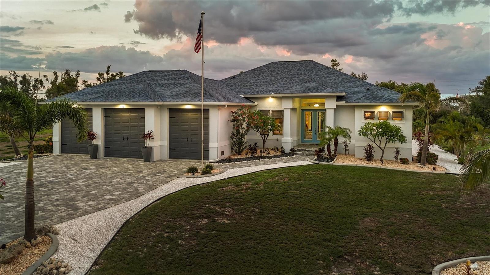 Built in 2019 this stunning 3 bed, plus den/study, 2 bath home sits on over half an acre of land, with a gorgeous heated pool and lanai and a car lover's dream 3 car garage. Located in the historic Vanderbilt developed neighborhood of Cape Haze with banyan lined streets, sidewalks to stroll to shopping and dining. Like all the homes in the neighborhood the house sits nicely back from the street, with a wide paver driveway and walkway up to the front door. Tall ceilings, large open kitchen and great room, custom wood cabinetry, stone counter tops, designer tile backsplash, high end appliances, plank tile flooring throughout, 8-foot zero corner sliding glass doors to the lanai, a full roll down screen and an outdoor kitchen on the lanai. Expansive paver lanai, beautifully designed pool with a sun shelf and in-pool seating. An incredible jumbo size 3 car garage with oversized stall doors, with two doors that are 9' wide by 10' tall and one 10'x10' middle door. Extra deep and tall ceilings, perfect for car lifts, storing boats, a workshop, and tremendous storage space. The home also comes with a very handy 10'x16' shed, perfect for even more storage. Cape Haze is a special waterfront community with membership in the Cape Haze POA there is usage of a dock and private beach on Don Pedro Island. A phenomenal location, Cape Haze is close to three full service marinas, numerous public and private golf courses, historic Boca Grande, miles of pristine sandy beaches and world-class fishing and boating.